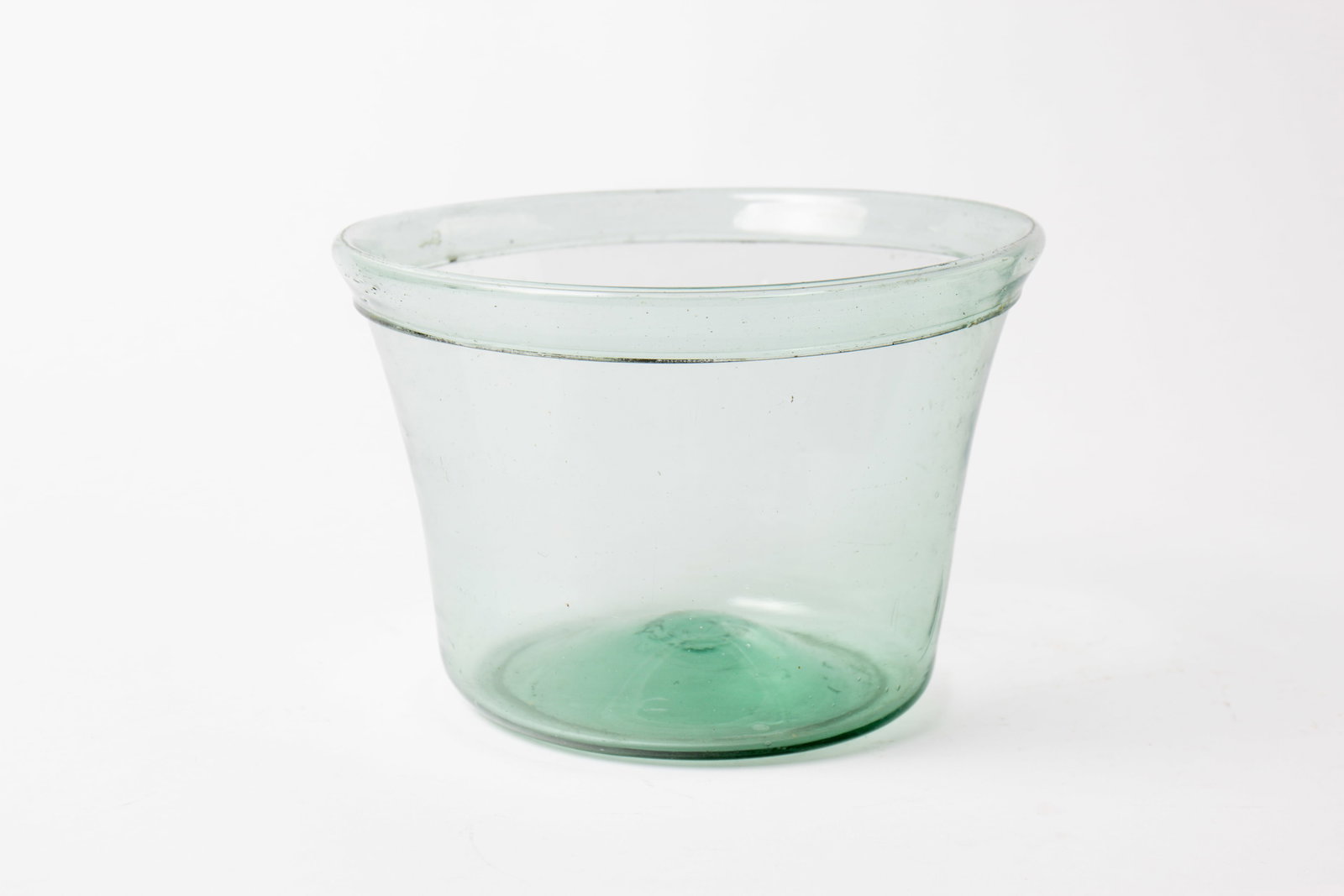 BLOWN GREEN GLASS MILK BOWL, POSSIBLY PITTSBURGH.: BLOWN GREEN GLASS MILK BOWL, POSSIBLY PITTSBURGH. American, second quarter 19th Century. Folded rim, slightly flared lip, broken pontil, and nice wear. 6"h. 8.75"d.