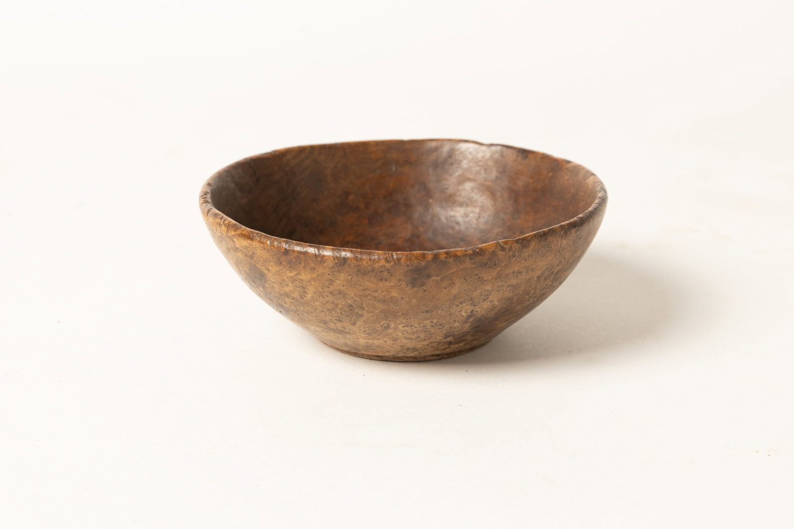 DIMINUTIVE TURNED ASH BURL BOWL.: DIMINUTIVE TURNED ASH BURL BOWL. American, 19th Century. Hand-turned bowl with pronounced foot, and nice form. Great color and surface. 2"h. 5.25"d. Provenance: Nancy Goff (Alliance, Ohio); Garry & De