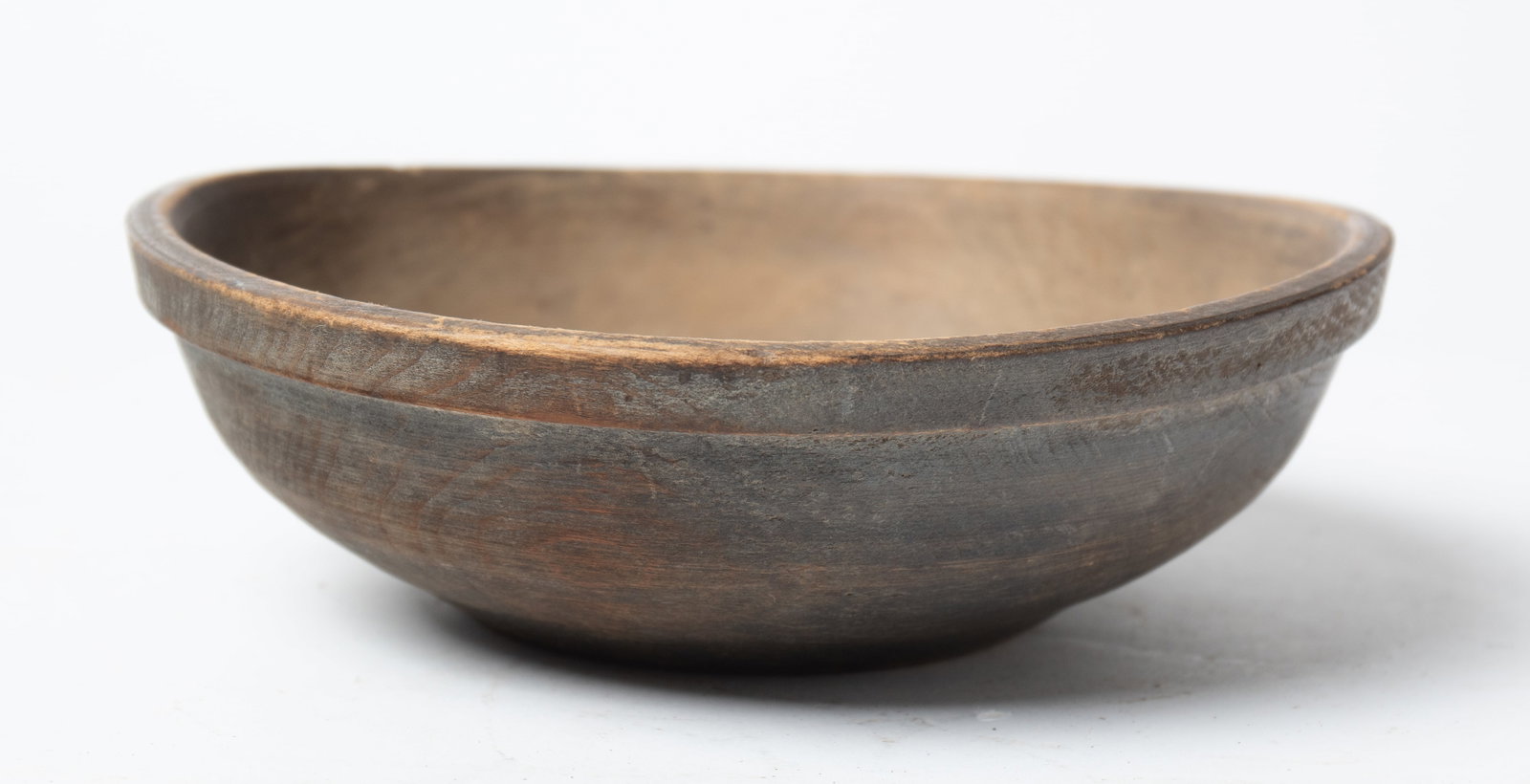 EARLY TURNED AND PAINTED WOODEN BOWL.: EARLY TURNED AND PAINTED WOODEN BOWL. American, early 19th Century. Turned bowl with a slight foot, pronounced rim, and with original slate blue paint. 2.25"h. 8"d. Provenance: Nancy Goff (Alliance, O