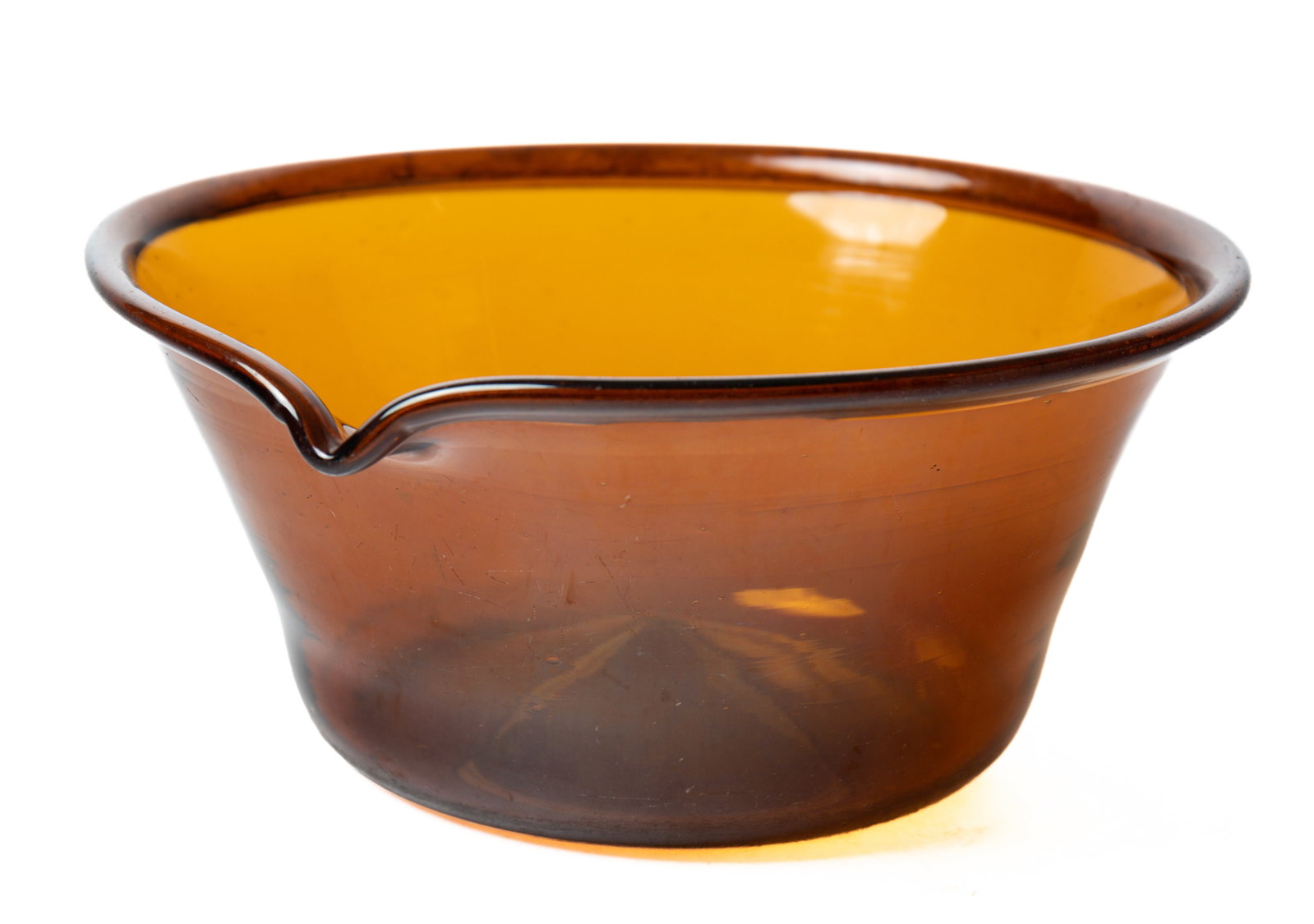 MIDWESTERN, POSSIBLY ZANESVILLE, OHIO AMBER GLASS MILK PAN.: MIDWESTERN, POSSIBLY ZANESVILLE, OHIO AMBER GLASS MILK PAN. Americans, second quarter 19th Century. Folded rim, well formed spout, canted sides, broken pontil, a few small seeds and nice wear on botto