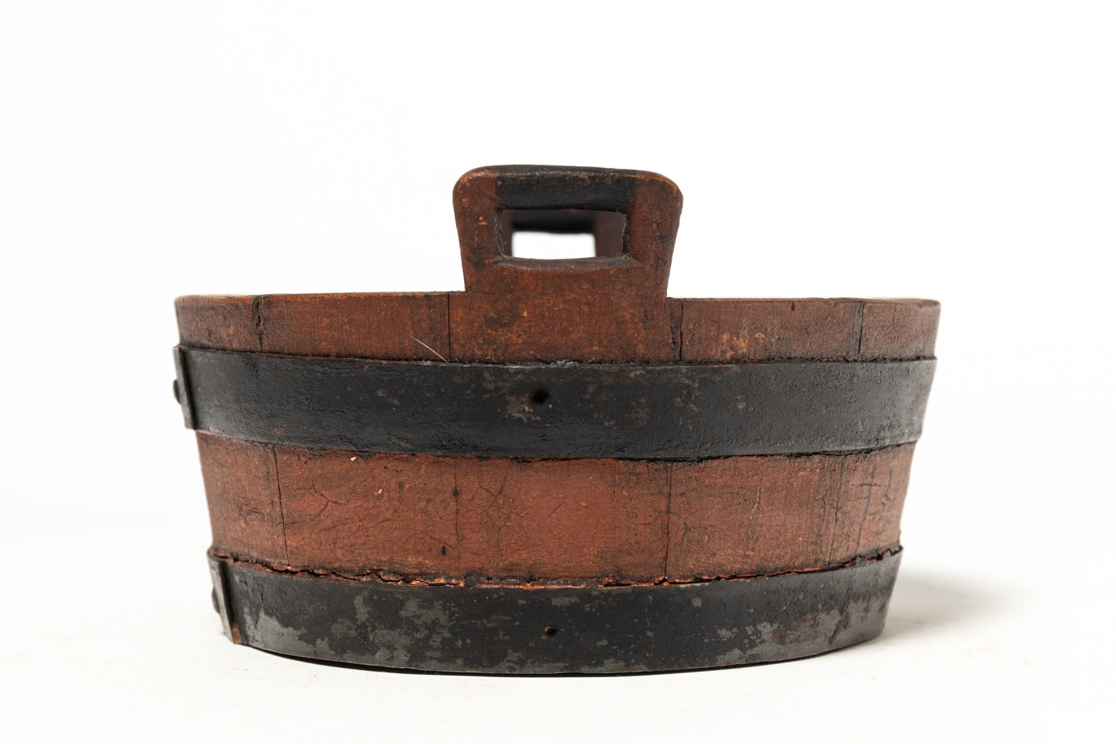 STAVE CONSTRUCTED HANDLED BUCKET WITH ORIGINAL PAINT.: STAVE CONSTRUCTED HANDLED BUCKET WITH ORIGINAL PAINT. American, 19th Century. Stave constructed bucket with two handles, iron hoops, and original salmon paint. 5"h. 8.75"w. Provenance: Nancy Goff