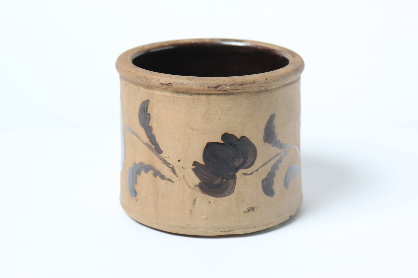 NEW GENEVA, PENNSYLVANIA TANWARE BUTTER CROCK.: NEW GENEVA, PENNSYLVANIA TANWARE BUTTER CROCK. American, 19th Century. Having a rolled lip above a cylindrical body decorated with three flowers, stems, and leaves; 4.88"h. Provenance: Nancy Goff