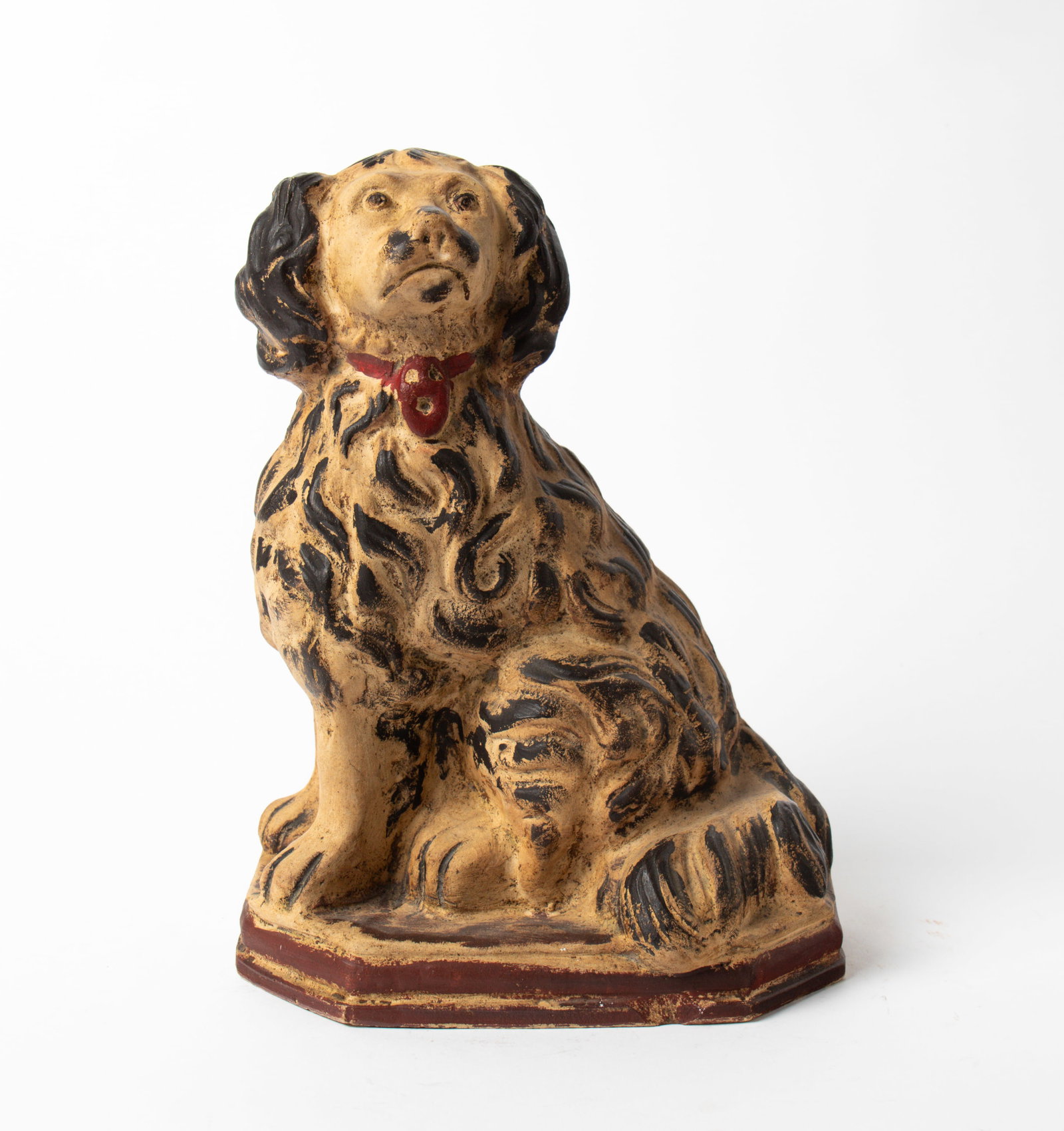 LARGE PAINT-DECORATED SEATED SPANIEL.: LARGE PAINT-DECORATED SEATED SPANIEL. American (possibly Atwater, Ohio), 19th Century. Depicting a seated spaniel with red collar and octagonal base; 13"h. 9.5"w. Provenance: Nancy Goff (Alliance, Ohi
