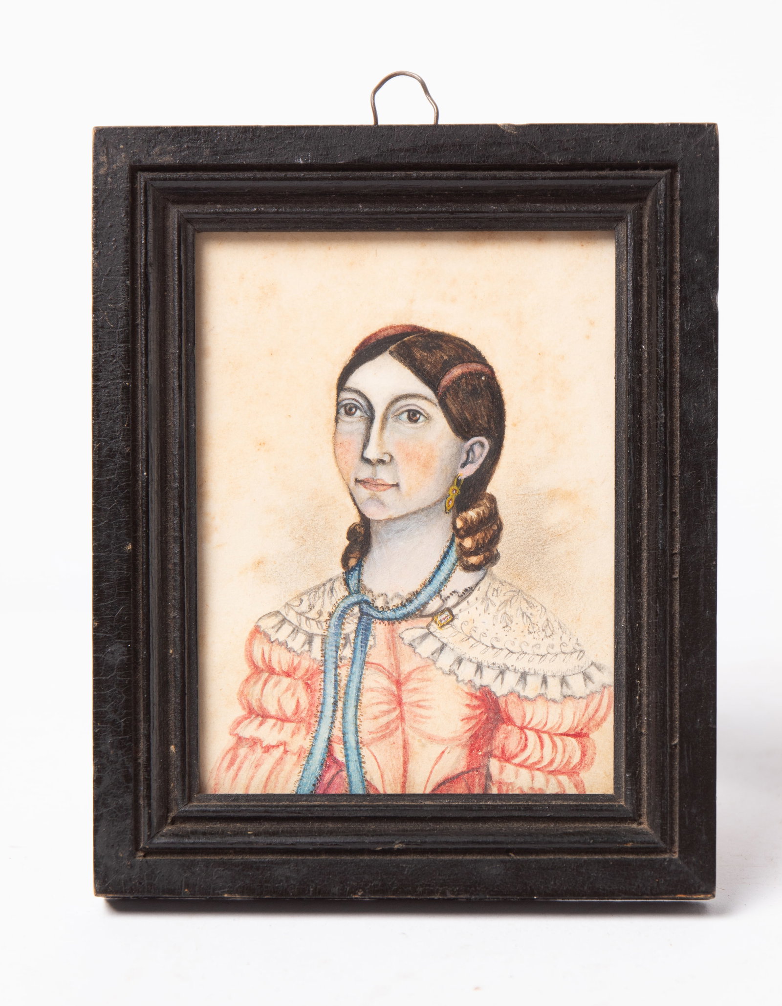 DIMINUTIVE WATERCOLOR PORTRAIT OF AN OHIO GIRL.: DIMINUTIVE WATERCOLOR PORTRAIT OF AN OHIO GIRL. American, 19th Century. Watercolor on paper. A young girl with barrettes in her hair with curls near her neck, rosy cheeks, a blue ribbon around her nec