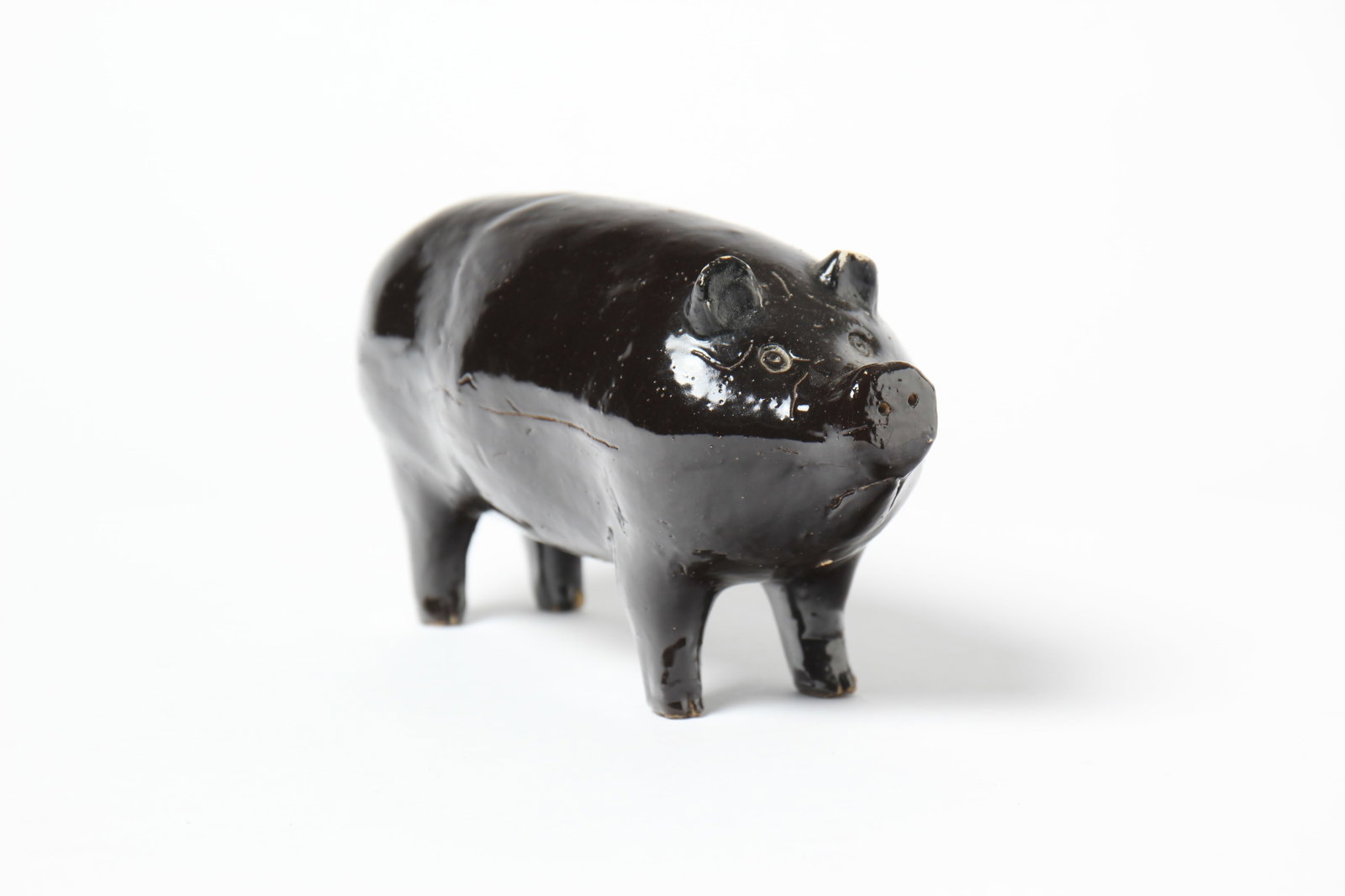 NAVARRE, OHIO STONEWARE PIG IN DARK BROWN GLAZE. (1 of 5)