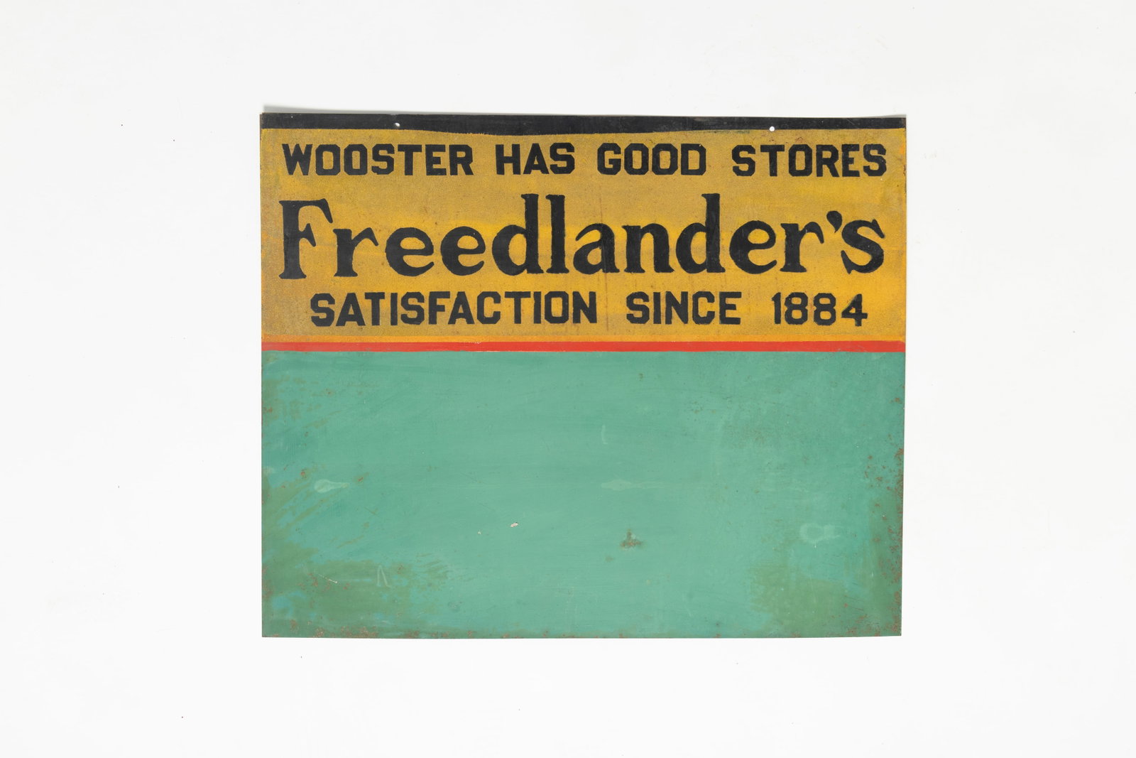 ROADSIDE PRODUCE ADVERTISING SIGN.: ROADSIDE PRODUCE ADVERTISING SIGN. American, early 20th Century. Sheet metal. Top reads "Wooster has good stores Freedlander's Satisfaction since 1884" above a blank area to write messages. 24.25"h.