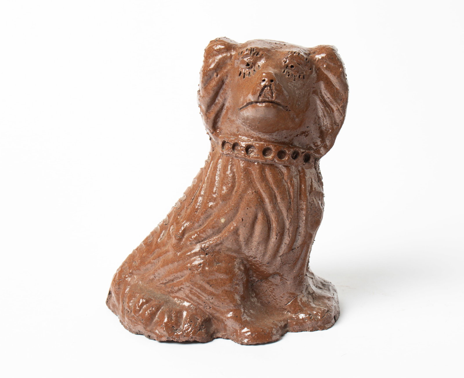 OHIO SEWER TILE SEATED "FLAT TOP" DOG.: OHIO SEWER TILE SEATED "FLAT TOP" DOG. American, 19th Century. Nicely detailed eyelashes and collar; with brown glaze; 9"h. 5"w. 7.5"d. Provenance: Nancy Goff (Alliance, Ohio).