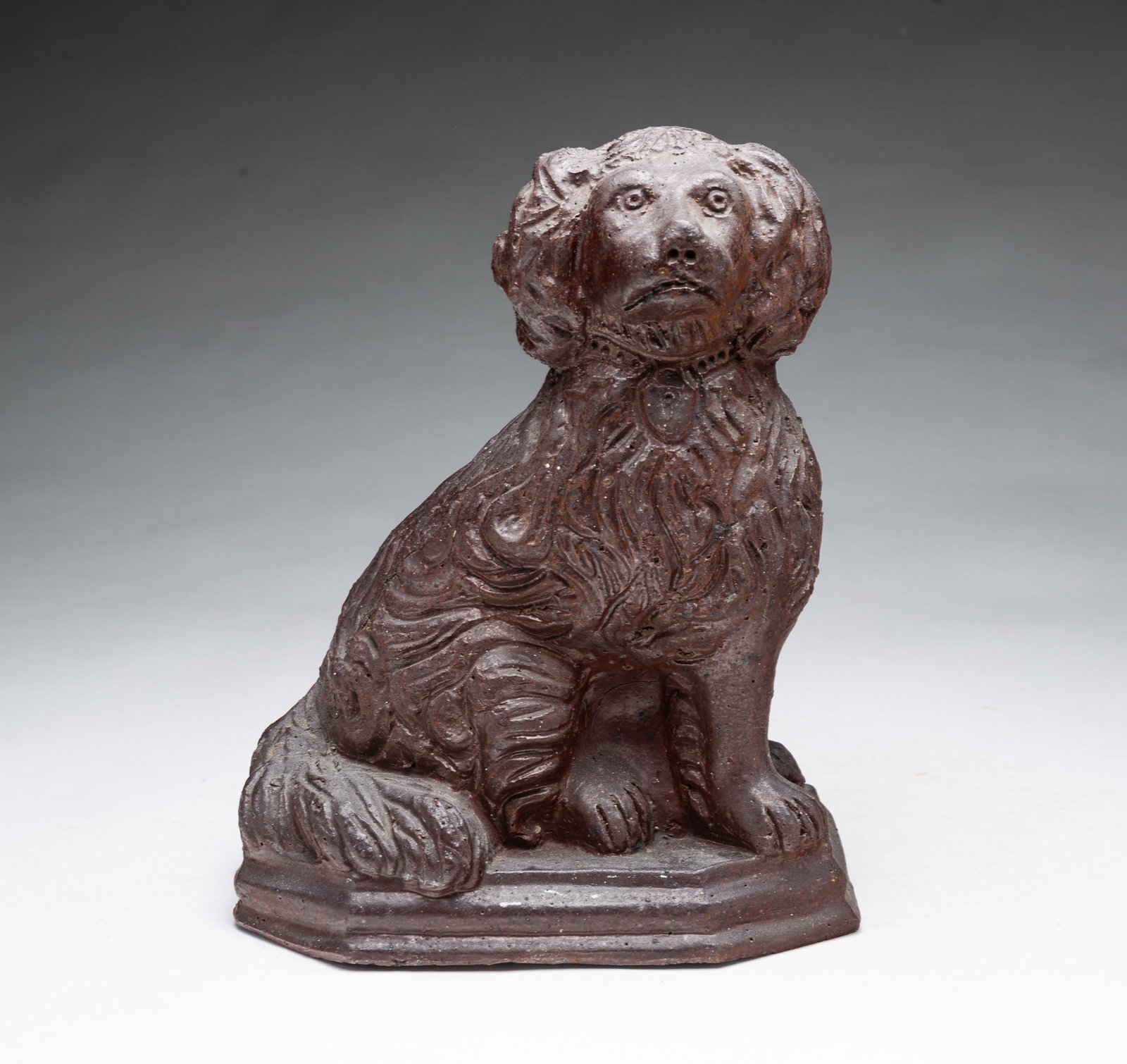 OHIO SEWER TILE SEATED SPANIEL.: OHIO SEWER TILE SEATED SPANIEL. American, early 20th Century. Nicely molded with tooled detail. 11"h. Provenance: From the Lifetime Collection of Charles and Margaret Gibbs (Salem, Ohio).