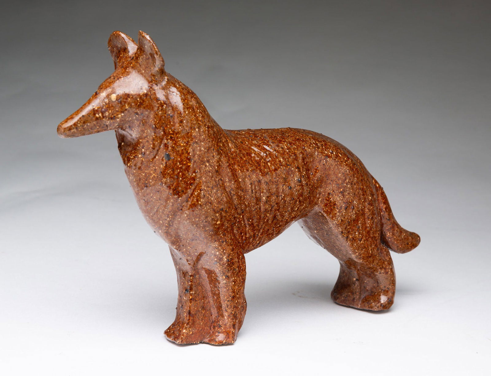 OHIO SEWER TILE COLLIE DOG.: OHIO SEWER TILE COLLIE DOG. American, late 19th Century. Standing dog with molded and incised decoration and light eyes in an allover motlled brown glaze. 7"h.