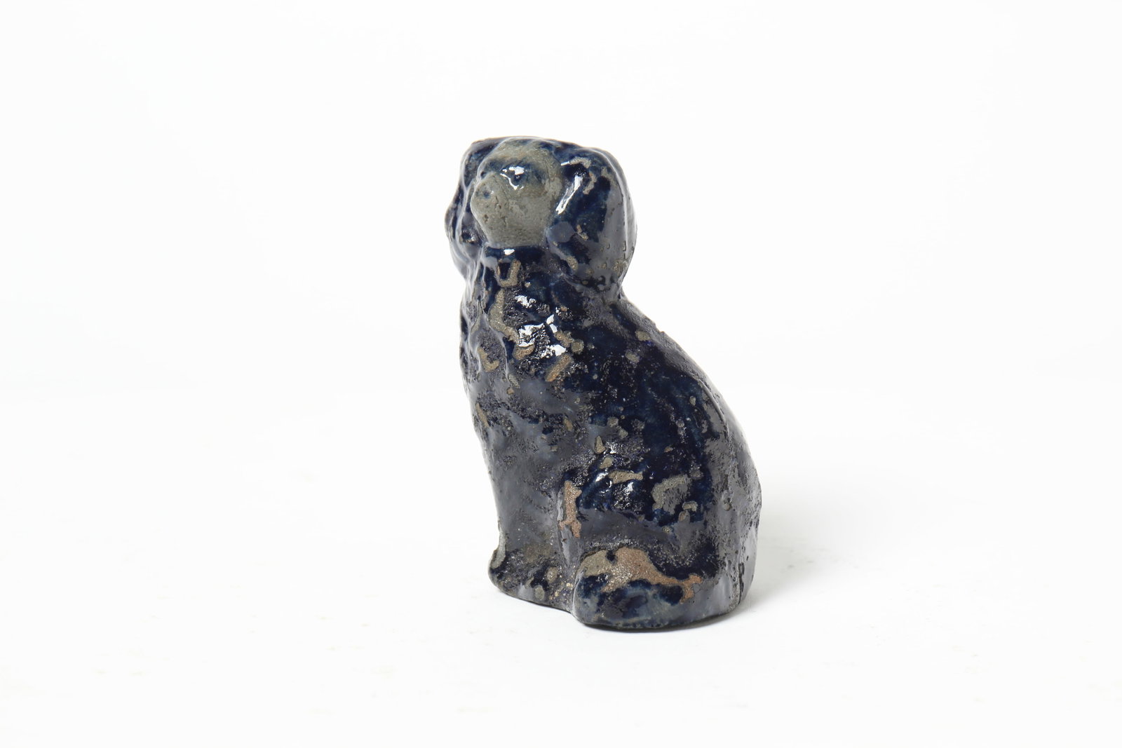 ATTRIBUTED TO BELL FAMILY (STRASBURG, VIRGINIA) MINIATURE COBALT-DECORATED STONEWARE SPANIEL.: ATTRIBUTED TO BELL FAMILY (STRASBURG, VIRGINIA) MINIATURE COBALT-DECORATED STONEWARE SPANIEL. American, 19th Century. Seated dog with molded ears, facial features, and fur; having cobalt-decorated