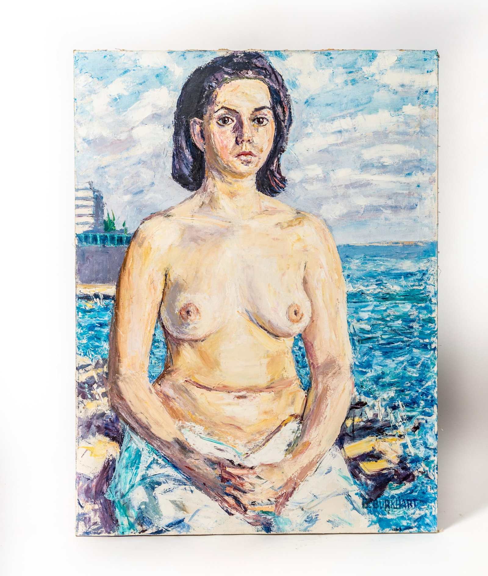 EMERSON BURKHART (OHIO, 1905 - 1969) OIL ON CANVAS OF A SEMINUDE FEMALE.: EMERSON BURKHART (OHIO, 1905 - 1969) OIL ON CANVAS OF A SEMINUDE FEMALE. American, 20th Century. Depicting a topless woman seated in the foreground with her hands clasped on her lap, seated on a rocky