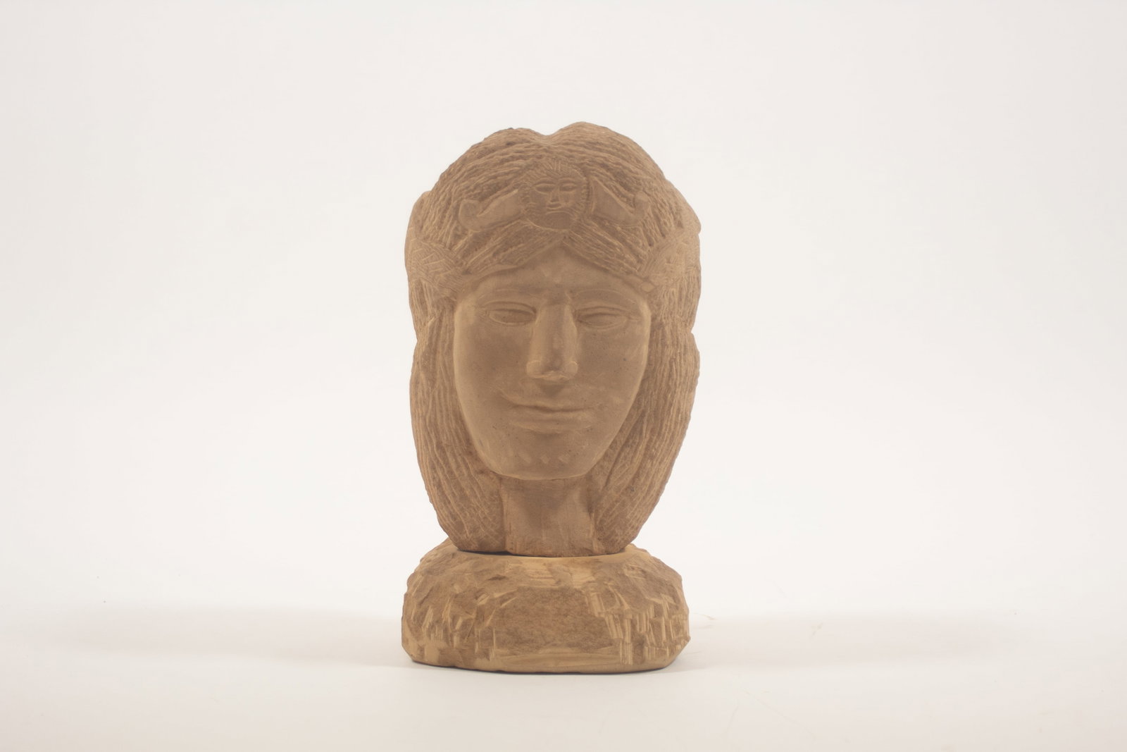 ERNEST "POPEYE" REED (OHIO, 1919 - 1985) FOLK ART CARVED STONE MERCURY BUST SCULPTURE.: ERNEST "POPEYE" REED (OHIO, 1919 - 1985) FOLK ART CARVED STONE MERCURY BUST SCULPTURE. American, 20th Century. A slightly square plinth topped with a depiction of Mercury with long hair, and wearing a
