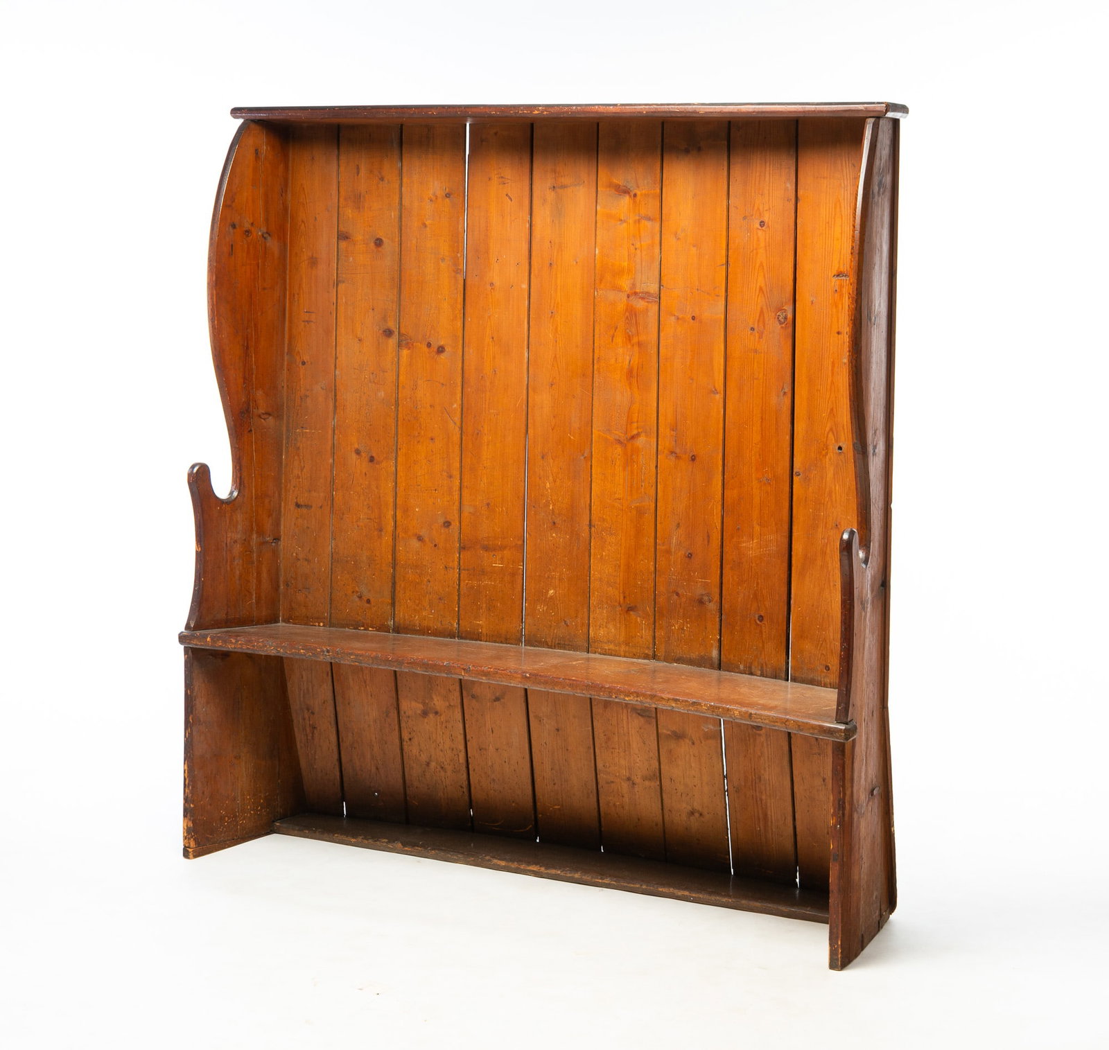 OAK HIGH-BACK FIRESIDE BENCH.: OAK HIGH-BACK FIRESIDE BENCH. American, 18th Century. Shaped ends with cut-outs, ten board back, one board seat, and cap board. 19.5" seat h. 65.25"h. 65.5"w.