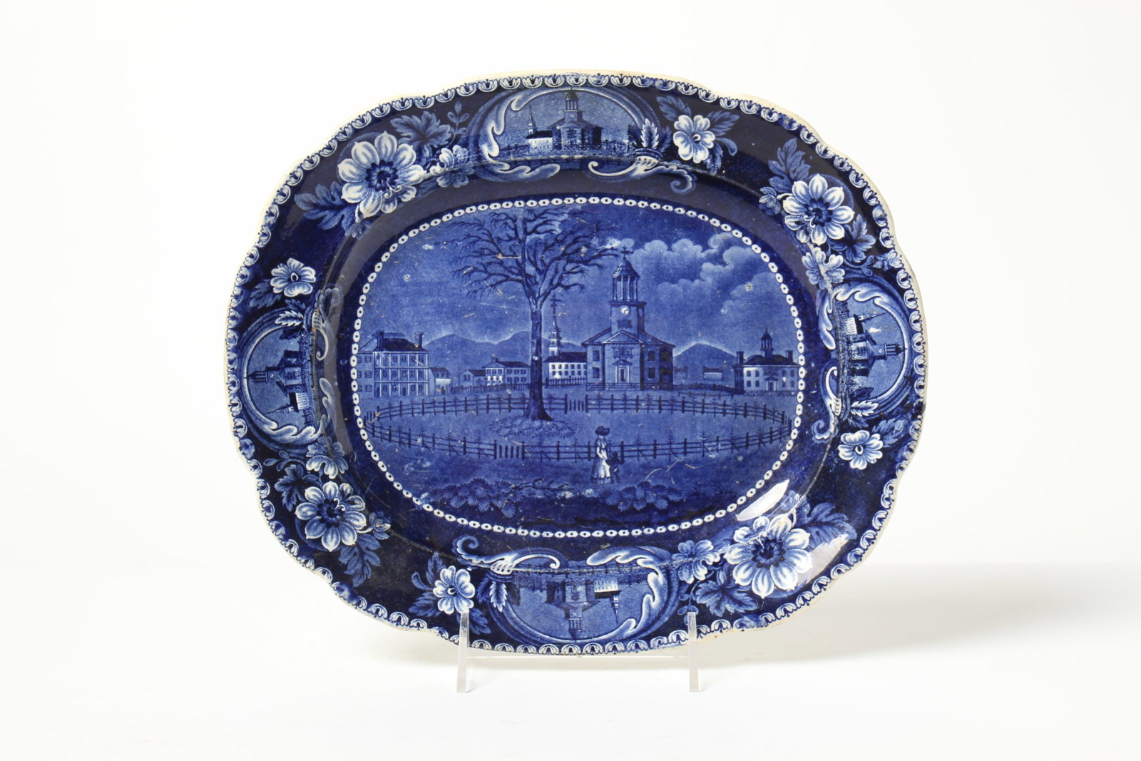 CLEWS HISTORICAL BLUE "WINTER VIEW OF PITTSFIELD, MASS".: CLEWS HISTORICAL BLUE "WINTER VIEW OF PITTSFIELD, MASS". England, mid- 19th Century. Floral border with reserves of churches, central cityscape of Pittsfield. Combed back and impressed mark. 14.75"w.