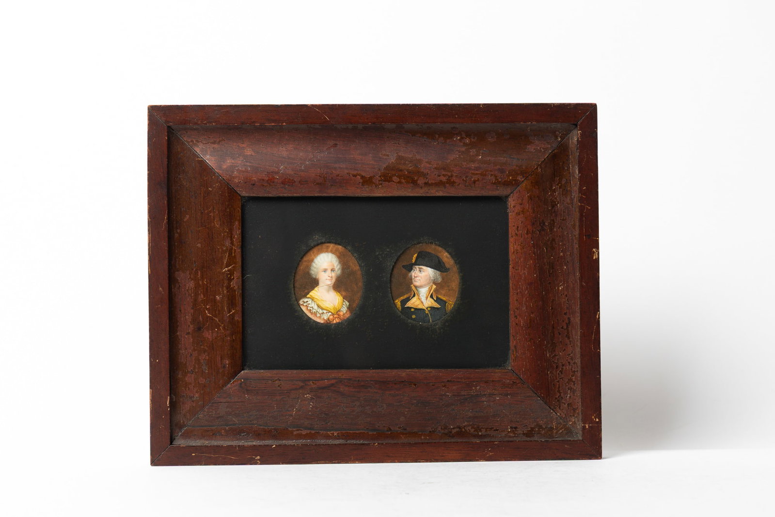 FRAMED MINIATURE PORTRAITS OF GEORGE AND MARTHA WASHINGTON.: FRAMED MINIATURE PORTRAITS OF GEORGE AND MARTHA WASHINGTON. American, early 19th Century. She wears a coral-colored gown, ruffled collar, and a yellow scarf, and he is in his Continental uniform and b