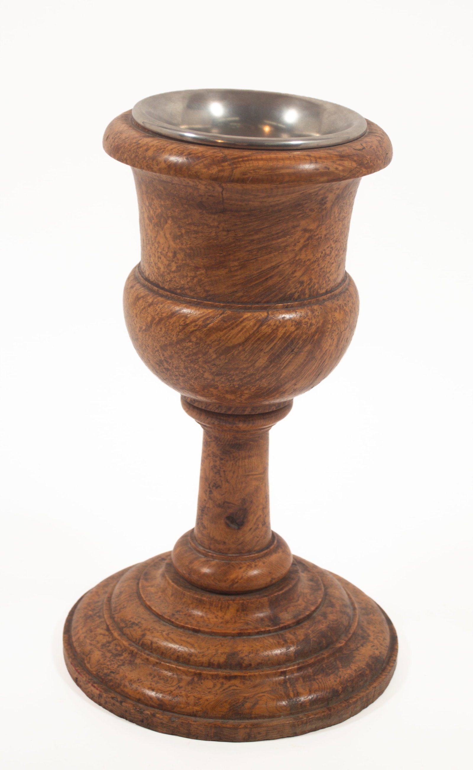 RARE ASH BURL COMMUNION CUP.: RARE ASH BURL COMMUNION CUP. Native American, mid- 19th Century. In two pieces. Urn from top with pewter insert on a round stepped base. 15.75"h. 9.5"d. at bottom. 7.5"d. at top. Illustrated and discu