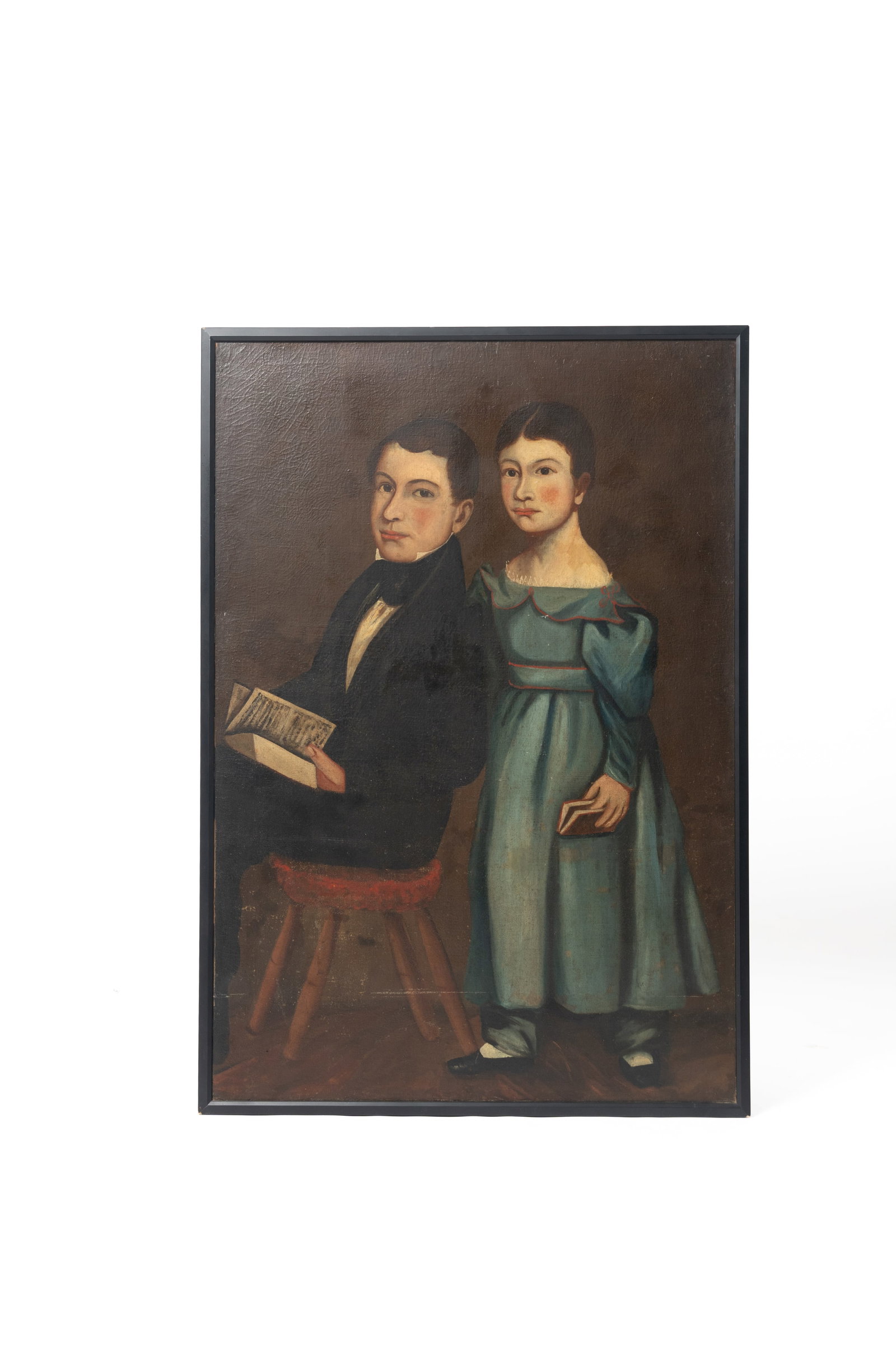 FULL-LENGTH FOLK ART PORTRAIT OF A BROTHER AND SISTER.: FULL-LENGTH FOLK ART PORTRAIT OF A BROTHER AND SISTER. American (New England), Circa 1820. Oil on canvas. A girl, standing wearing a blue dress with a lace collar, her brown hair parted down the cente