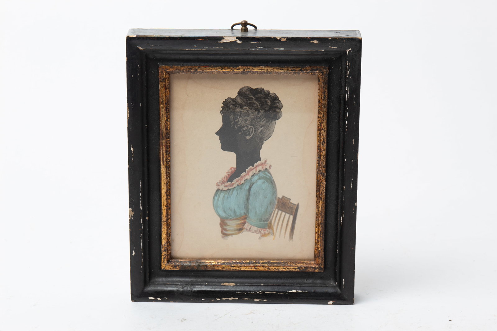 DIMINUTIVE WATERCOLOR OF A WOMAN IN A BLUE DRESS.: DIMINUTIVE WATERCOLOR OF A WOMAN IN A BLUE DRESS. American, 19th Century. Watercolor on paper. A silhouette of a woman with her hair in an updo, sitting in a stencil-decorated chair, wearing a blue dr
