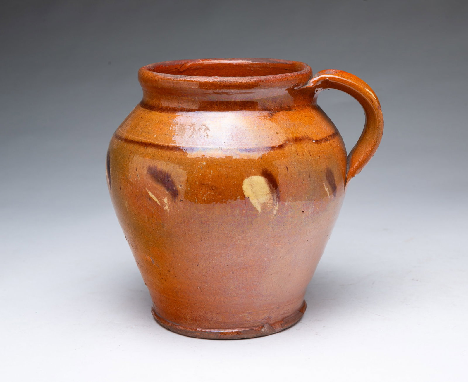 POLYCHROME GLAZED REDWARE JAR WITH HANDLE. (1 of 4)