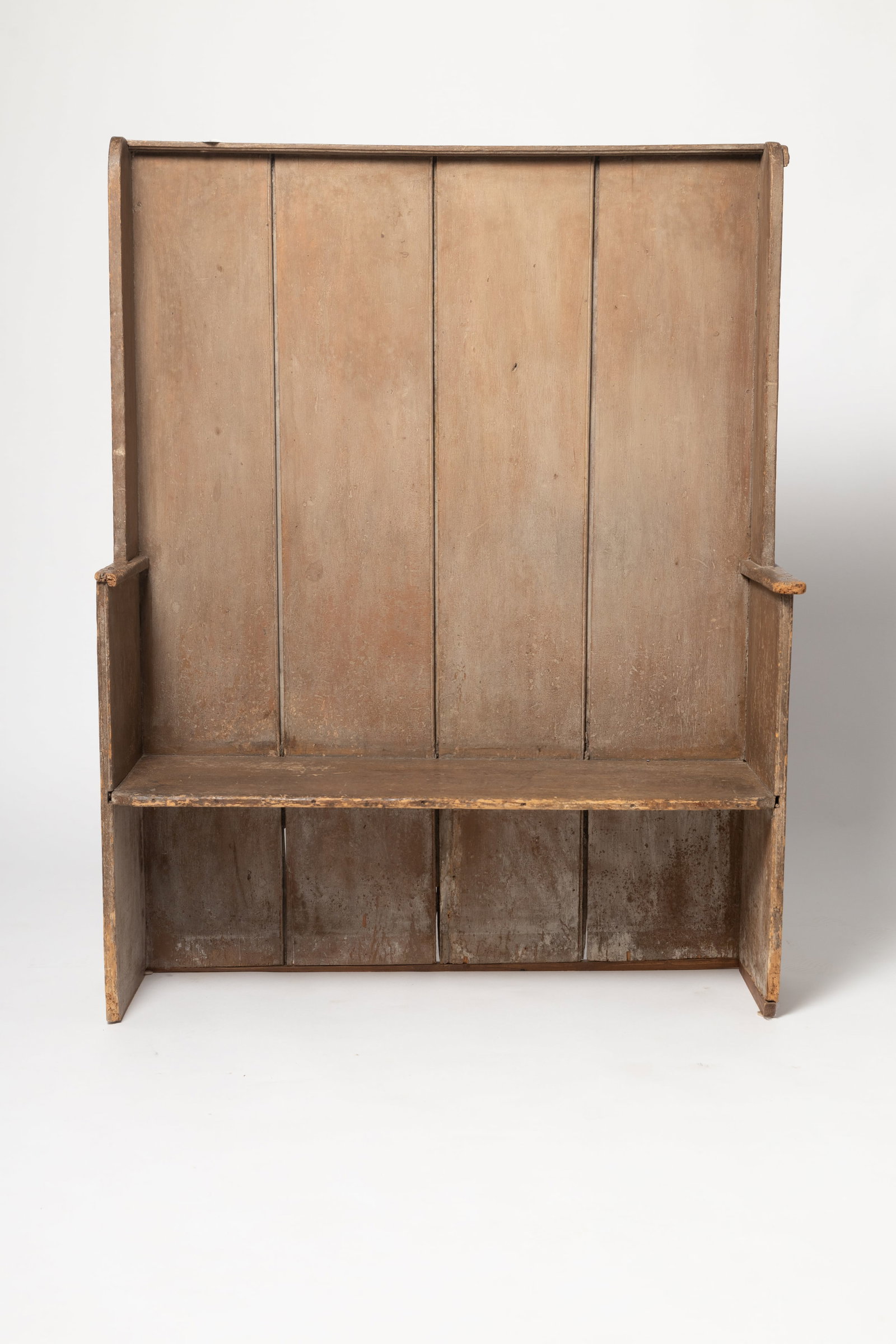 NEW YORK STATE HIGH BACK FIRESIDE BENCH IN ORIGINAL TAUPE PAINT.: NEW YORK STATE HIGH BACK FIRESIDE BENCH IN ORIGINAL TAUPE PAINT. American, Second half 18th Century. Pine. Simple rosehead nail construction, one board ends with applied armrests, and tongue and groov