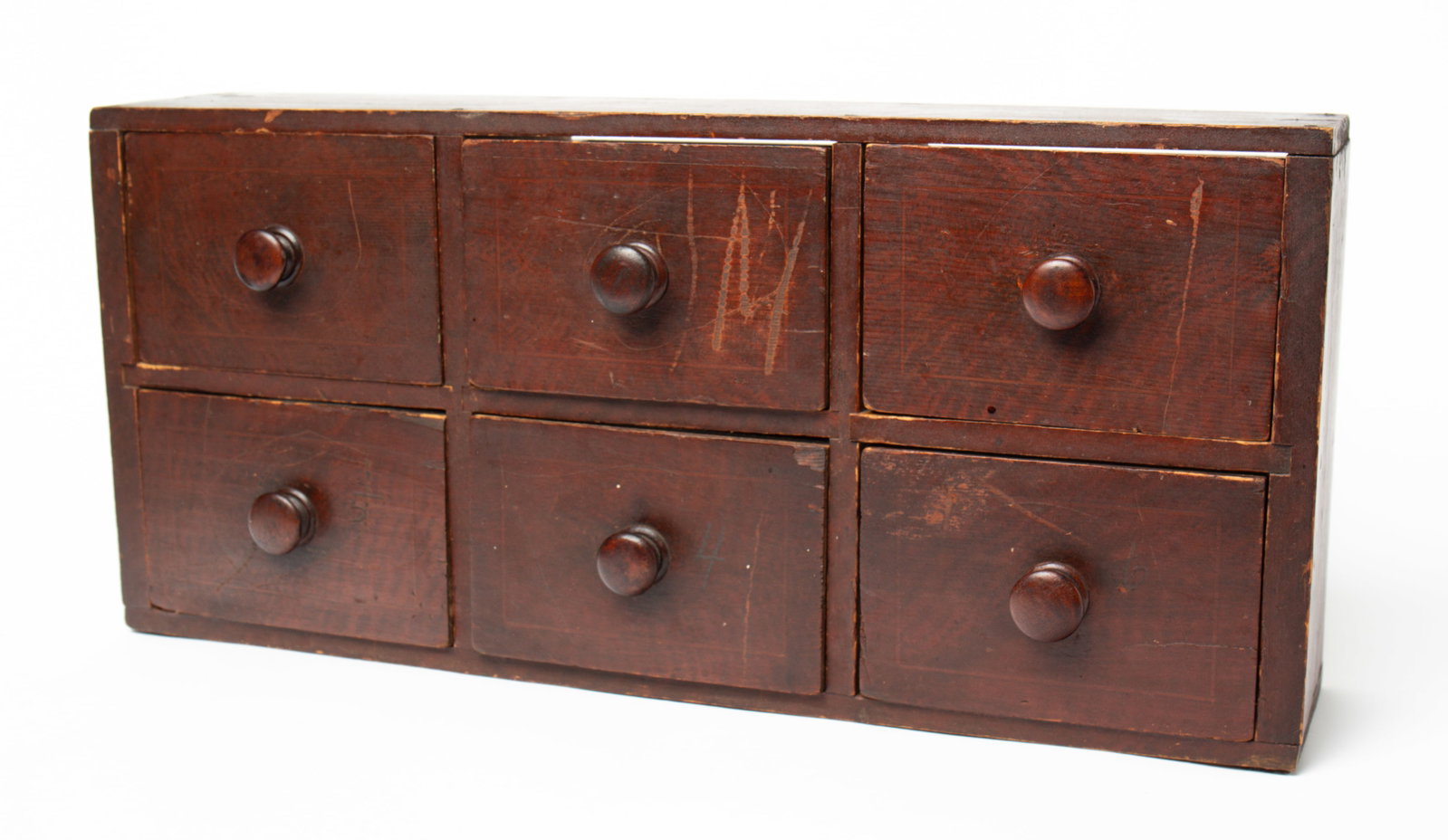 NEW ENGLAND CASE OF DRAWERS IN ORIGINAL GRAIN PAINT.: NEW ENGLAND CASE OF DRAWERS IN ORIGINAL GRAIN PAINT. American, First half 19th Century. Pine. Case with simple square nail construction, six dovetailed drawers with turned knobs and front scored throu