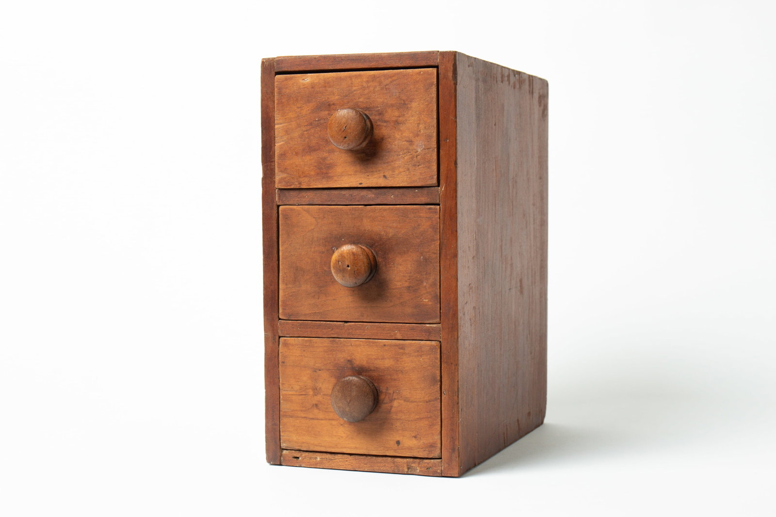 CASE OF THREE DRAWERS.: CASE OF THREE DRAWERS. American, 19th Century. Wood. Retaining an old patina; having a dovetailed case and three stacked, dovetailed drawers with round handles; 12"h. 6"w. 9.5"d. Provenance: Nancy Gof