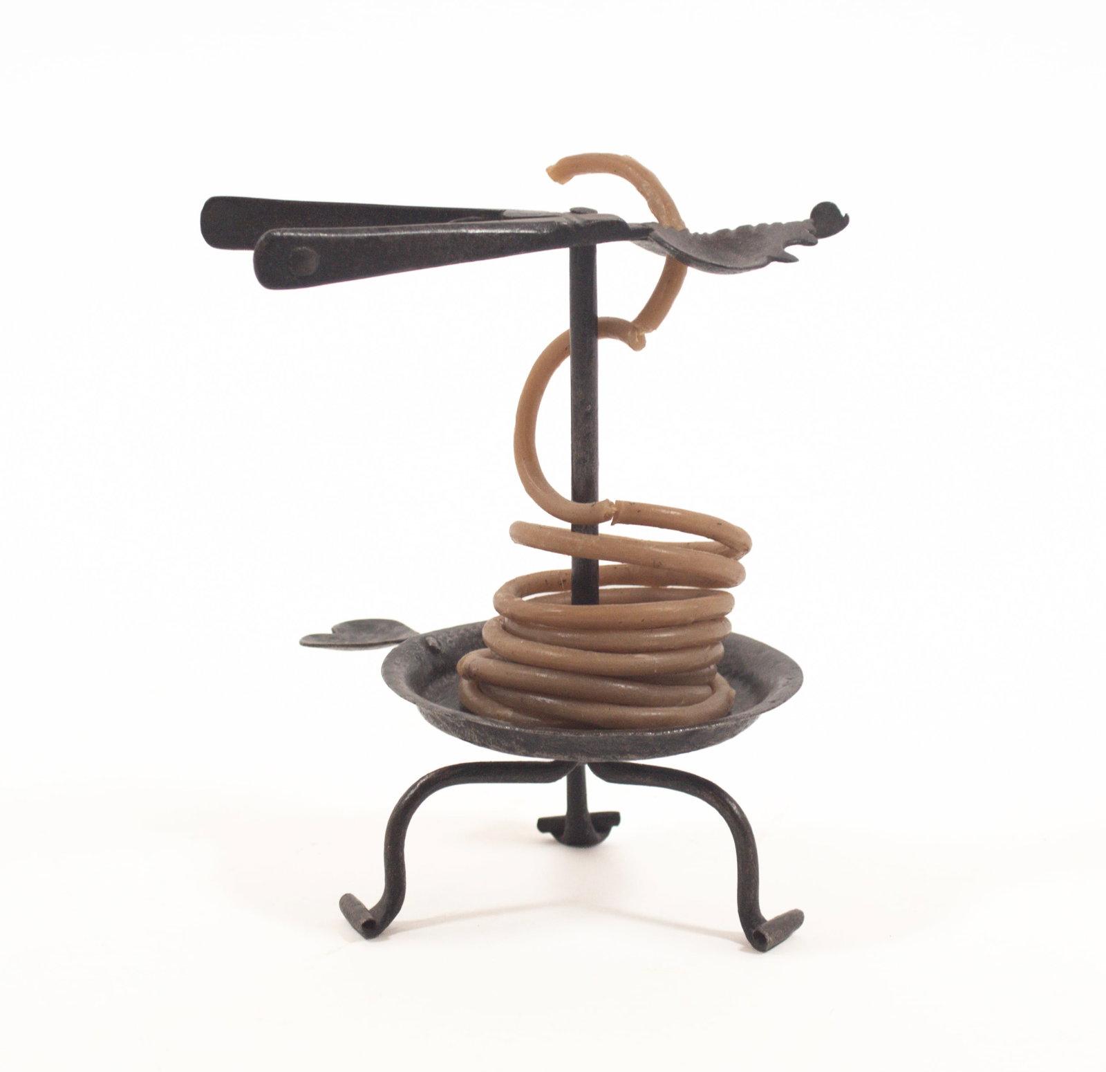 WROUGHT-IRON TAPER JACK WITH HEART HANDLE.: WROUGHT-IRON TAPER JACK WITH HEART HANDLE. American, 19th Century. Simple shaft with circular-form base, tripod legs, top fitted with a spring-tension holder, fitted with period coiled wax taper, and 