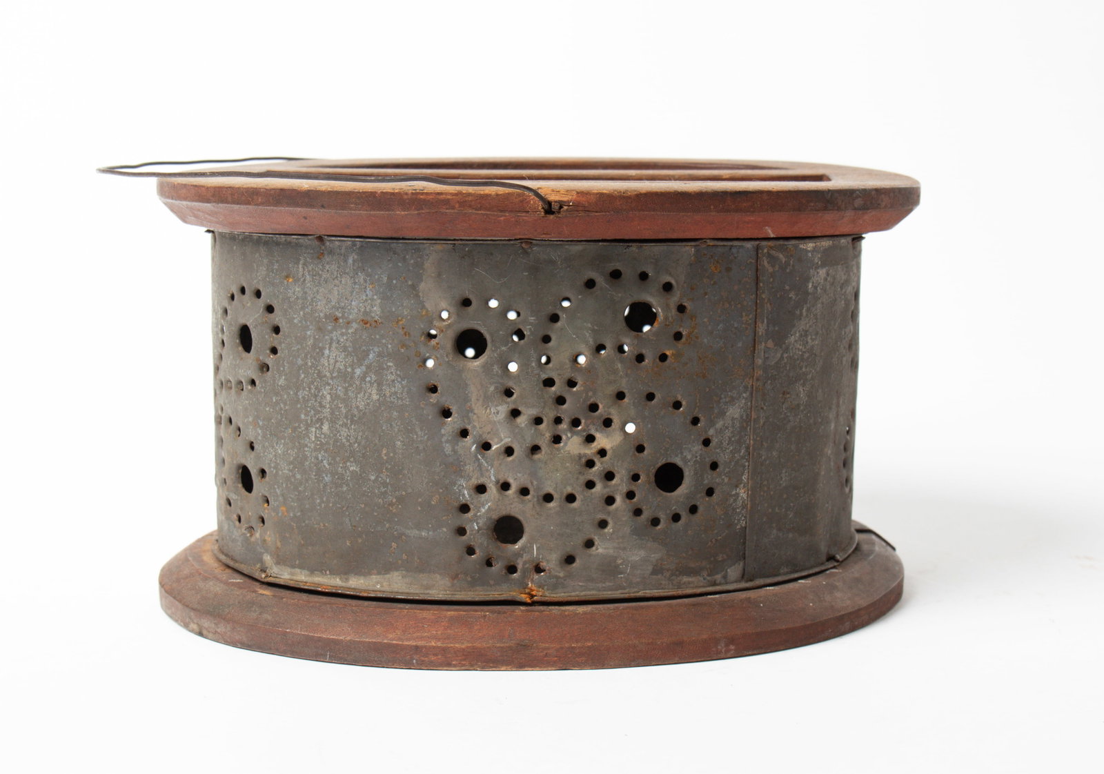 PUNCHED TIN OVAL FOOTWARMER WITH PINWHEELS. (1 of 3)