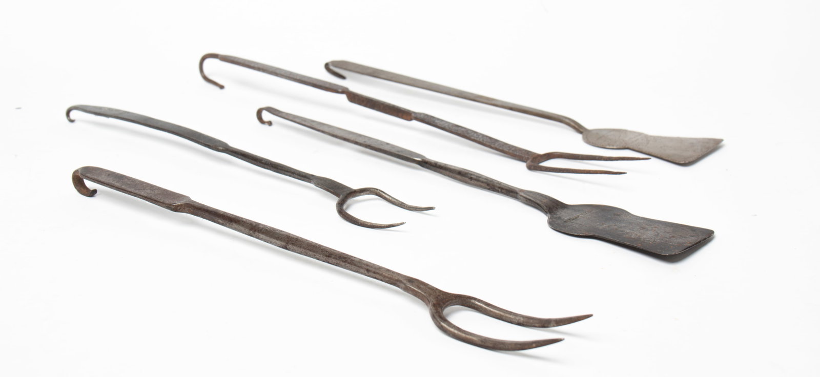 FIVE STAMPED FORGED IRON HEARTHSIDE SPATULAS AND FORKS. (1 of 5)