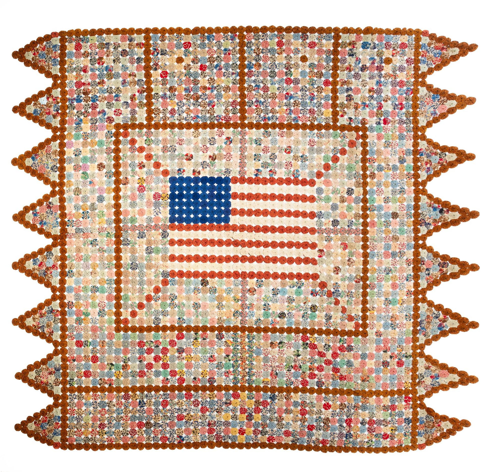 UNITED STATES FLAG YO-YO QUILT.: UNITED STATES FLAG YO-YO QUILT. Second half 19th Century. Cotton. Hand-stitched in solid and patterned fabrics. Flag at center surrounded by patterned circles in a brown grid. Sawtooth border. 86"w.