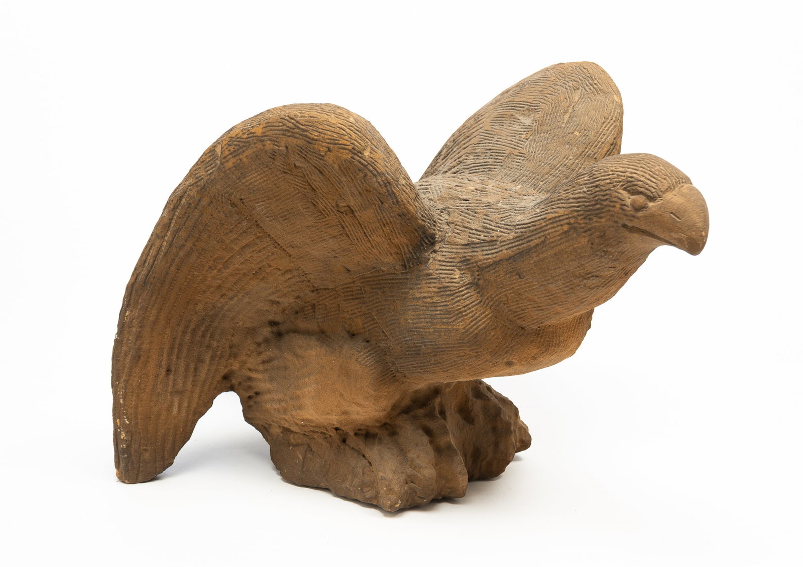 ERNEST "POPEYE" REED (OHIO, 1919-1985) FOLK ART CARVED STONE EAGLE SCULPTURE.: ERNEST "POPEYE" REED (OHIO, 1919-1985) FOLK ART CARVED STONE EAGLE SCULPTURE. American, 20th Century. A perched eagle with a textured body and wings pulled back. 12"h. 13"w. 21.5"l. Provenance: From