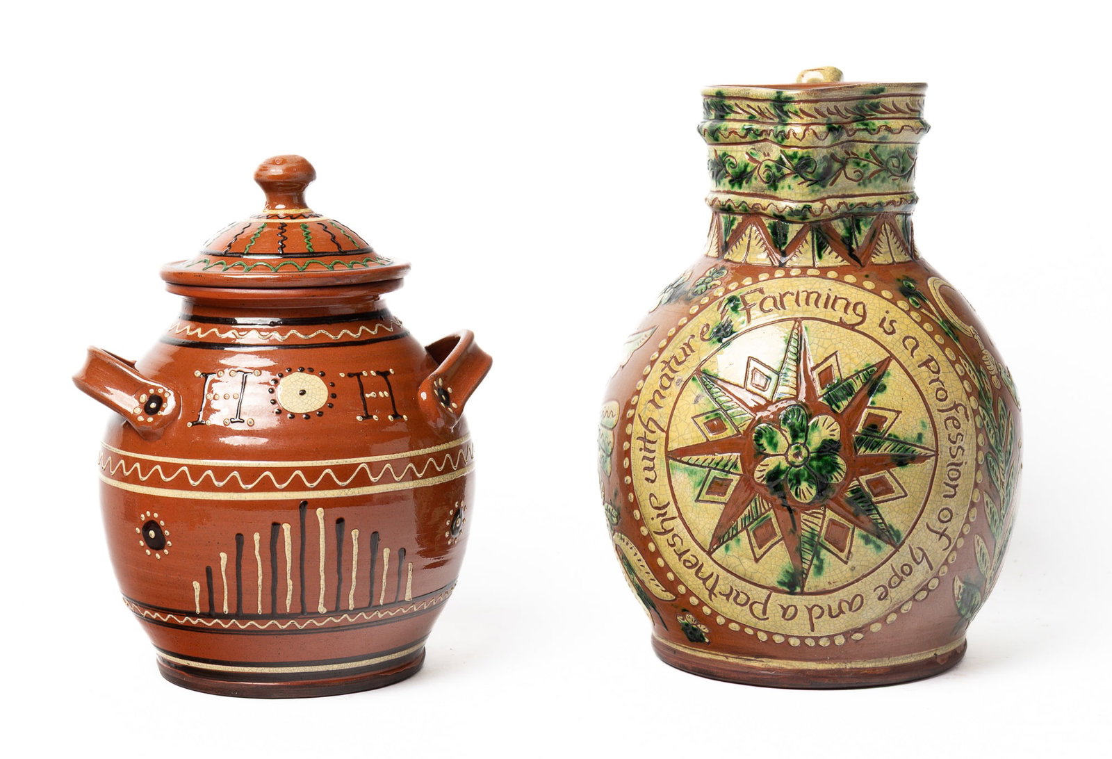 TURTLE CREEK REDWARE PITCHER AND LIDDED JAR WITH SLIP DECORATION.: TURTLE CREEK REDWARE PITCHER AND LIDDED JAR WITH SLIP DECORATION. American (Ohio), contemporary. Pitcher with bulbous body, applied handle with scrolled end, incised compass rose, tulips and love bird