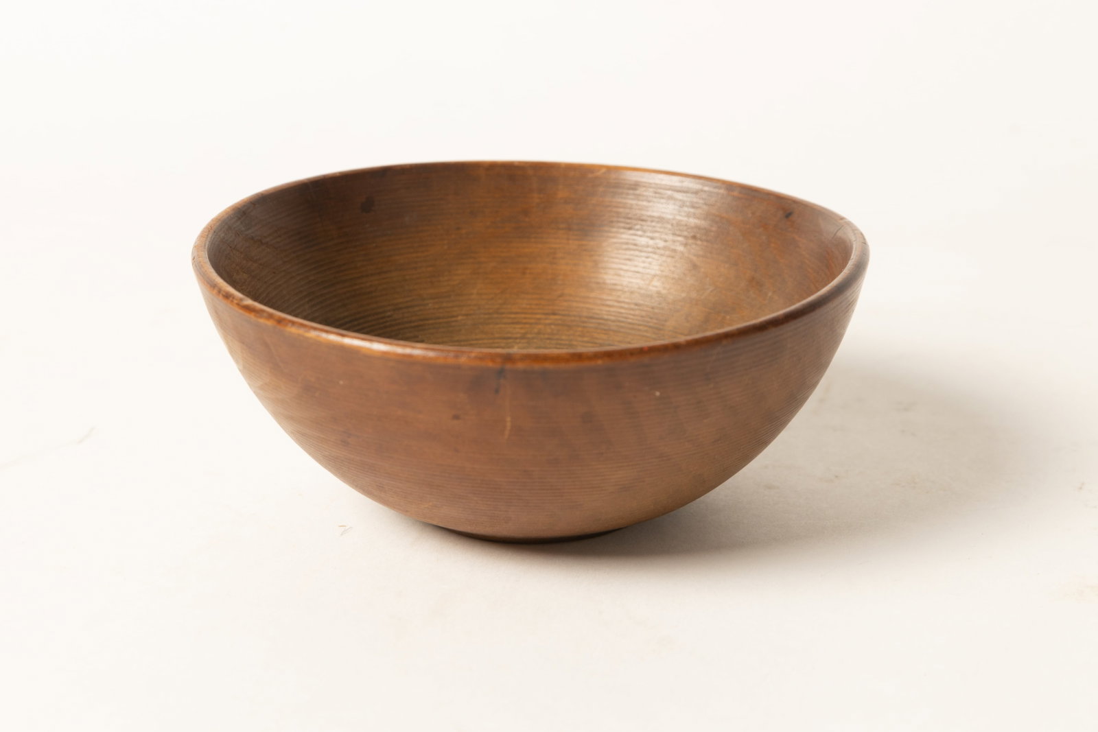 DIMINUTIVE TREENWARE BOWL WITH BANDING.: DIMINUTIVE TREENWARE BOWL WITH BANDING. American, 19th Century. Diminutive bowl, pronounced foot, and incised banding with a nice surface. 2.25"h. 5.25"d. Provenance: Nancy Goff (Alliance, Ohio);