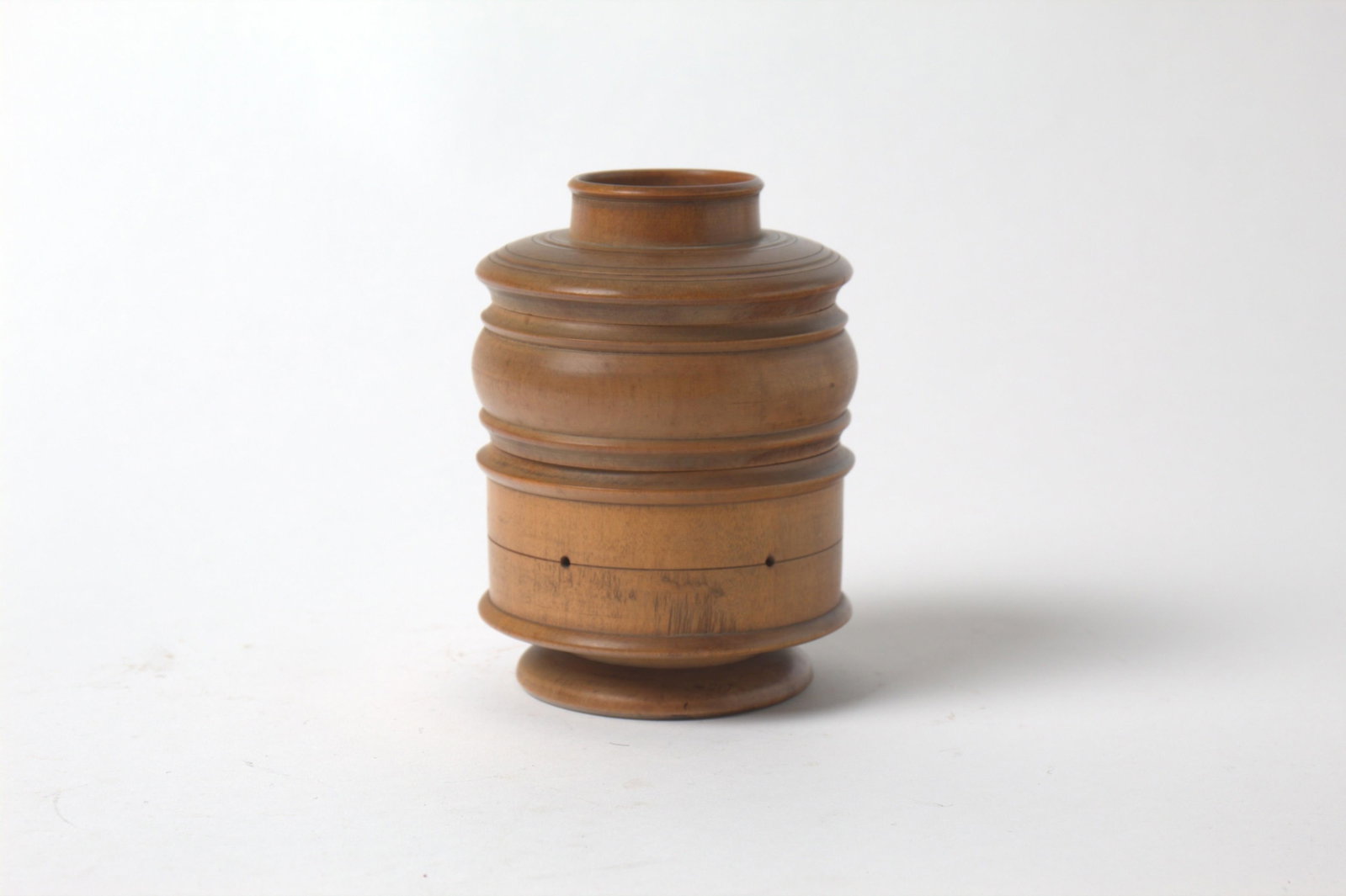 TREEN DOUBLE-COMPARTMENT THREAD CADDY.: TREEN DOUBLE-COMPARTMENT THREAD CADDY. American, 19th Century. Top compartment with lid; bottom with holders and thread can be threaded thru to the outside; 6.63"h. 5"d. Provenance: Nancy Goff
