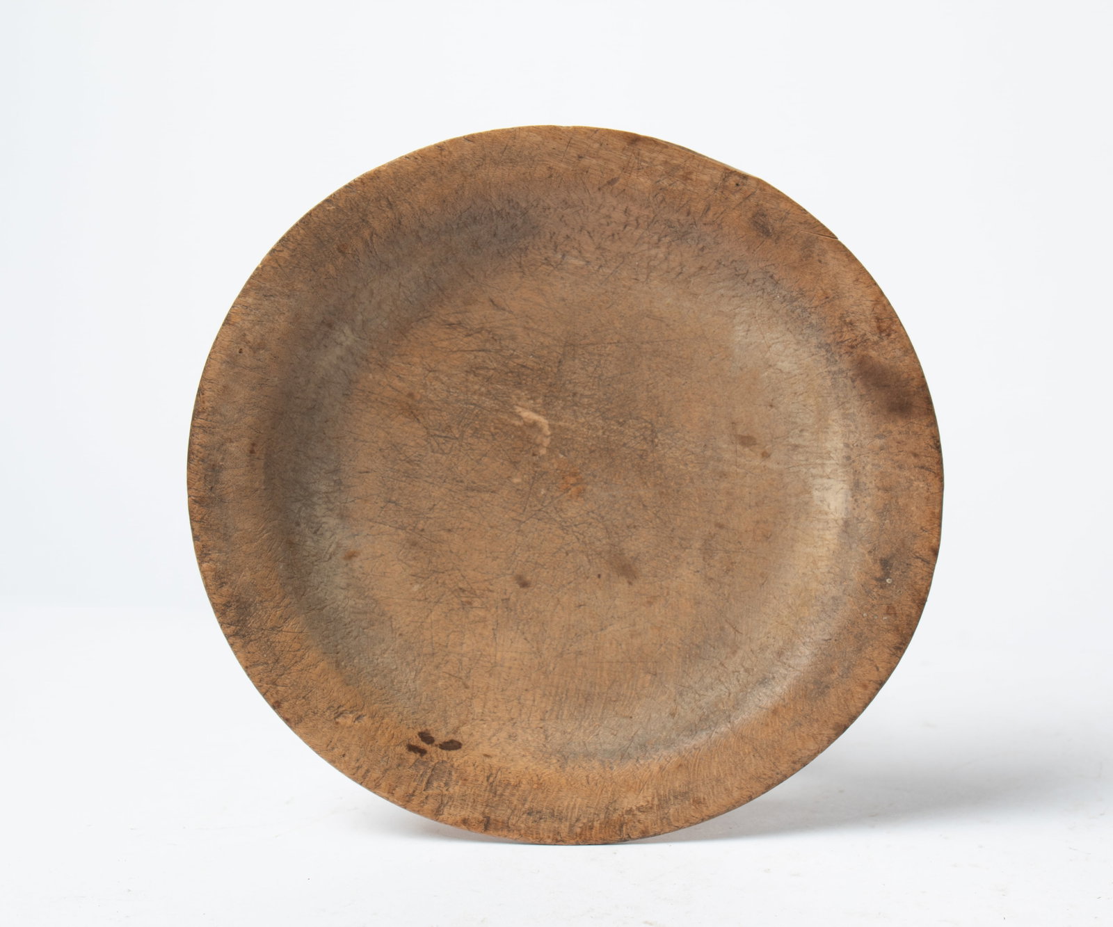 DEEP TREENWARE PLATE.: DEEP TREENWARE PLATE. American, 19th Century. A turned plate with a rim and nice wear. Slightly out of round. 1"h. 8"w. 7.5"d. Provenance: Nancy Goff (Alliance, Ohio).