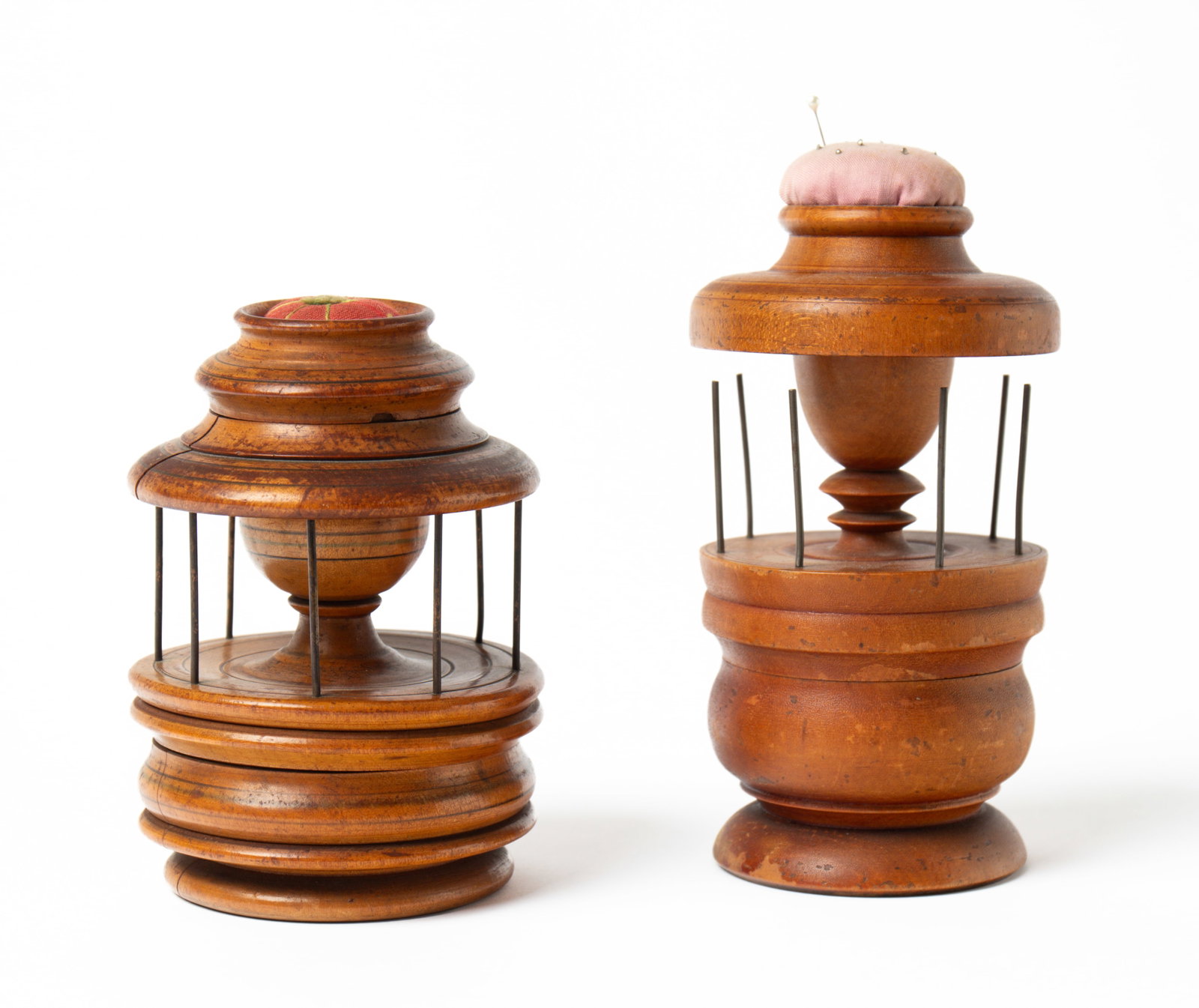 TWO TREEN SEWING CADDIES.: TWO TREEN SEWING CADDIES. American, 19th Century. Each with a pin cushion top above a thread holder; Tallest, 7.5"h. 4"d. Provenance: Nancy Goff (Alliance, Ohio).