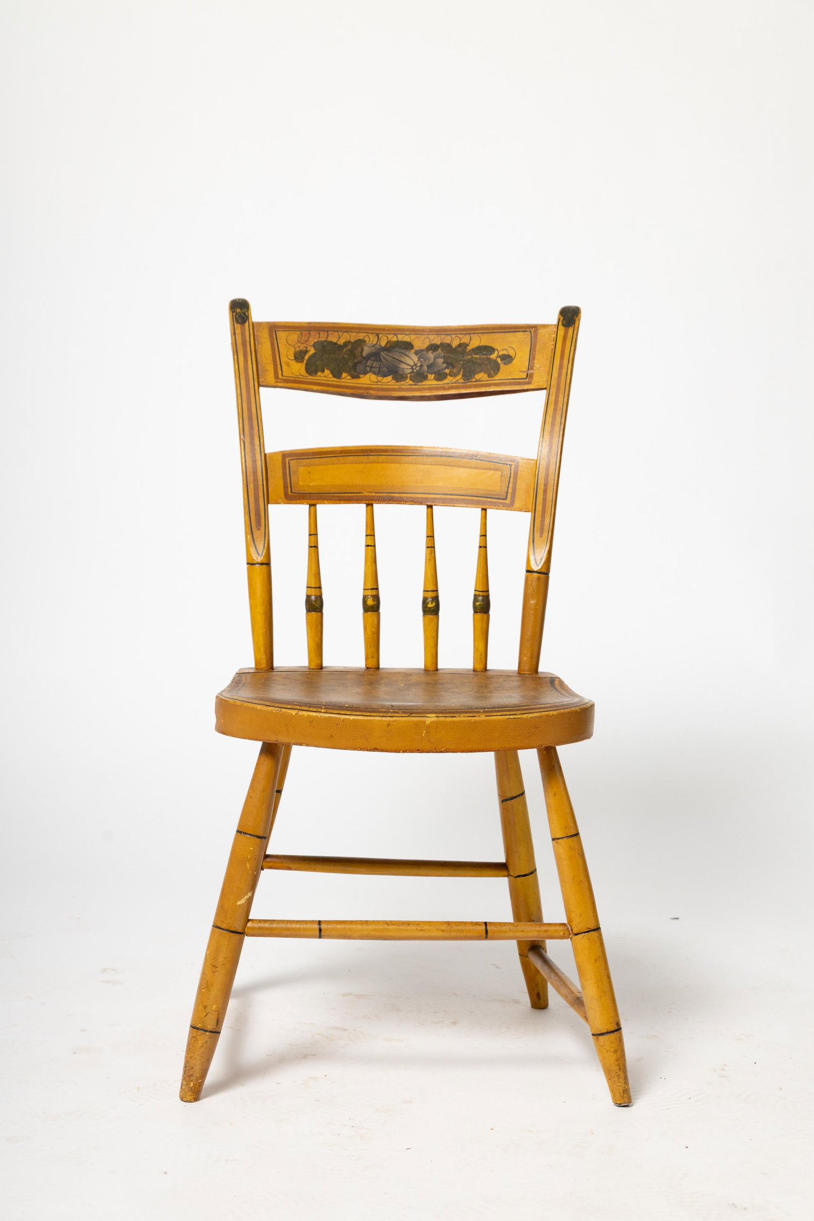 NEW ENGLAND HALF SPINDLE BACK CHAIR IN ORIGINAL MUSTARD YELLOW PAINT AND DECORATION.: NEW ENGLAND HALF SPINDLE BACK CHAIR IN ORIGINAL MUSTARD YELLOW PAINT AND DECORATION. American, Second quarter 19th Century. Mixed woods. Plank seat, legs, and rungs with bamboo turnings, tan and