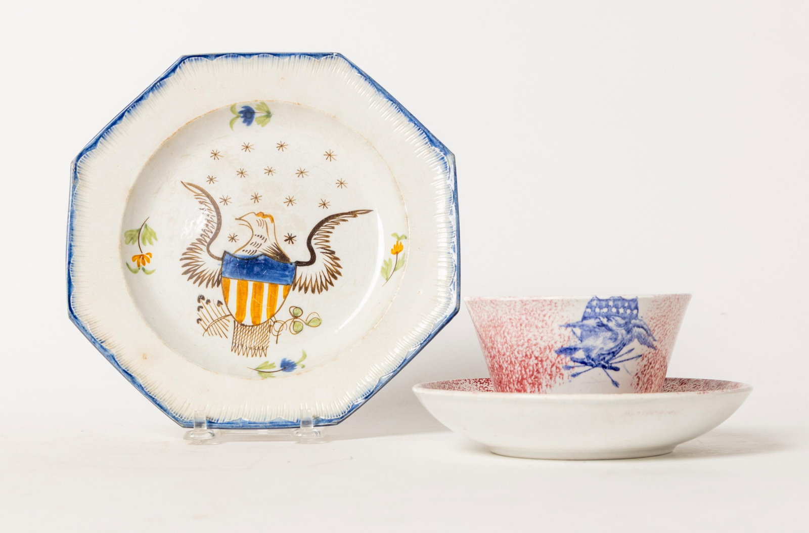 TWO STAFFORDSHIRE ITEMS WITH EAGLE DECORATION.: TWO STAFFORDSHIRE ITEMS WITH EAGLE DECORATION. England, mid- 19th Century. An octagonal blue feather-edge plate with eagle and shield center, fifteen overhead stars surrounded by four flower sprigs,