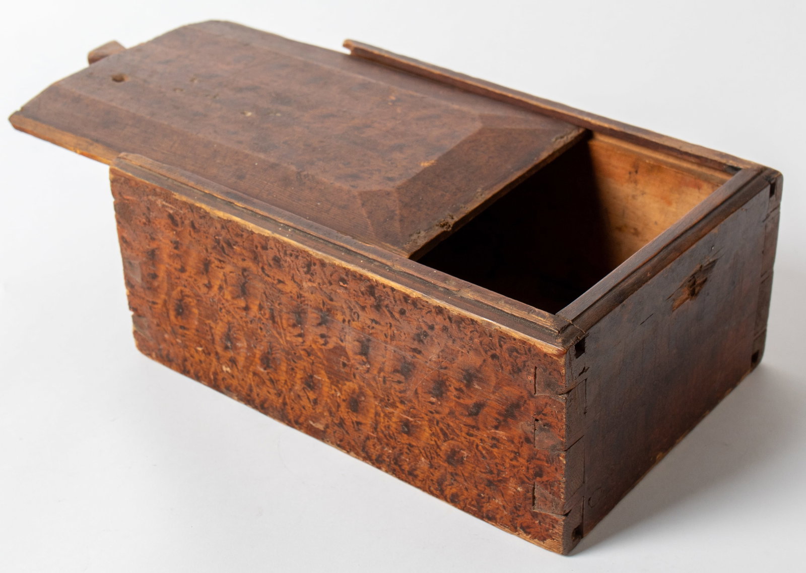 VINEGAR-GRAINED SLIDE LID BOX.: VINEGAR-GRAINED SLIDE LID BOX. American, 19th Century. Pine. Lid with beveled sides and triangular pull, an illegible name written on inside of lid, dovetailed case with allover orange and black