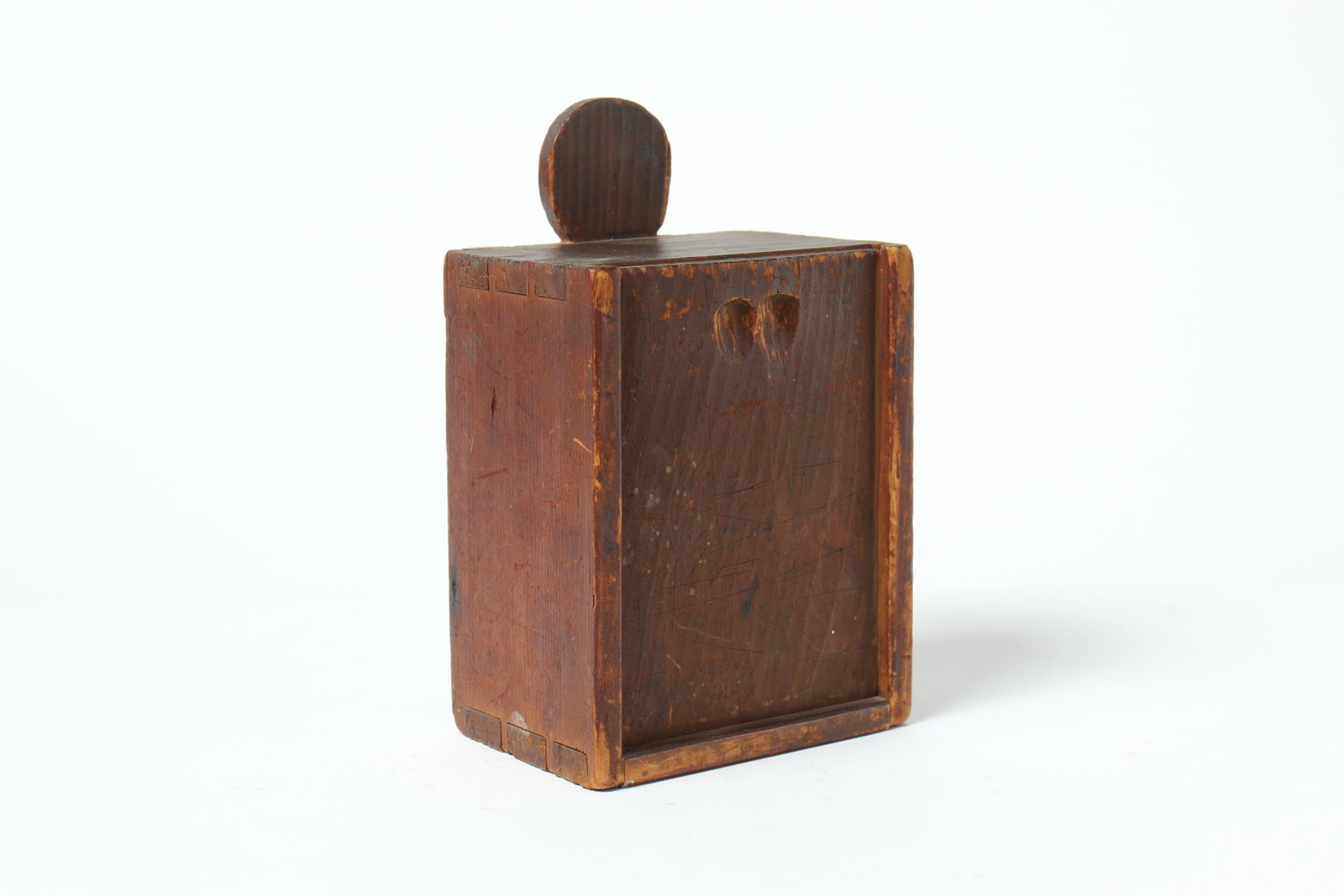 SLIDE-LID CANDLEBOX IN ORIGINAL RED PAINT.: SLIDE-LID CANDLEBOX IN ORIGINAL RED PAINT. American, 19th Century. Having a dovetailed case and square nails, a double finger hold, and a lollipop back; in original red paint with old inscription on