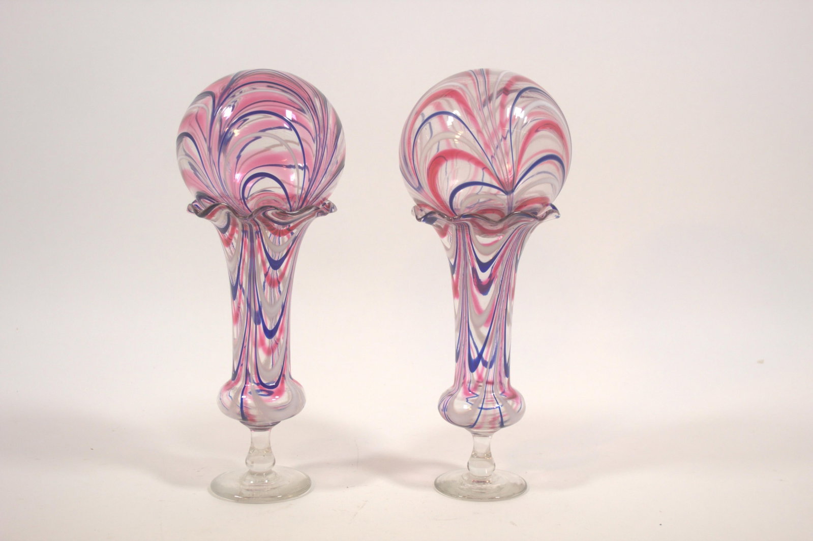 PAIR OF PATRIOTIC BLOWN GLASS RED, WHITE, AND BLUE NAILSEA VASES.: PAIR OF PATRIOTIC BLOWN GLASS RED, WHITE, AND BLUE NAILSEA VASES. American (likely West Virginia), mid- 19th Century. Vases, each with red, white, and blue looping in the body, ruffled rims, clear