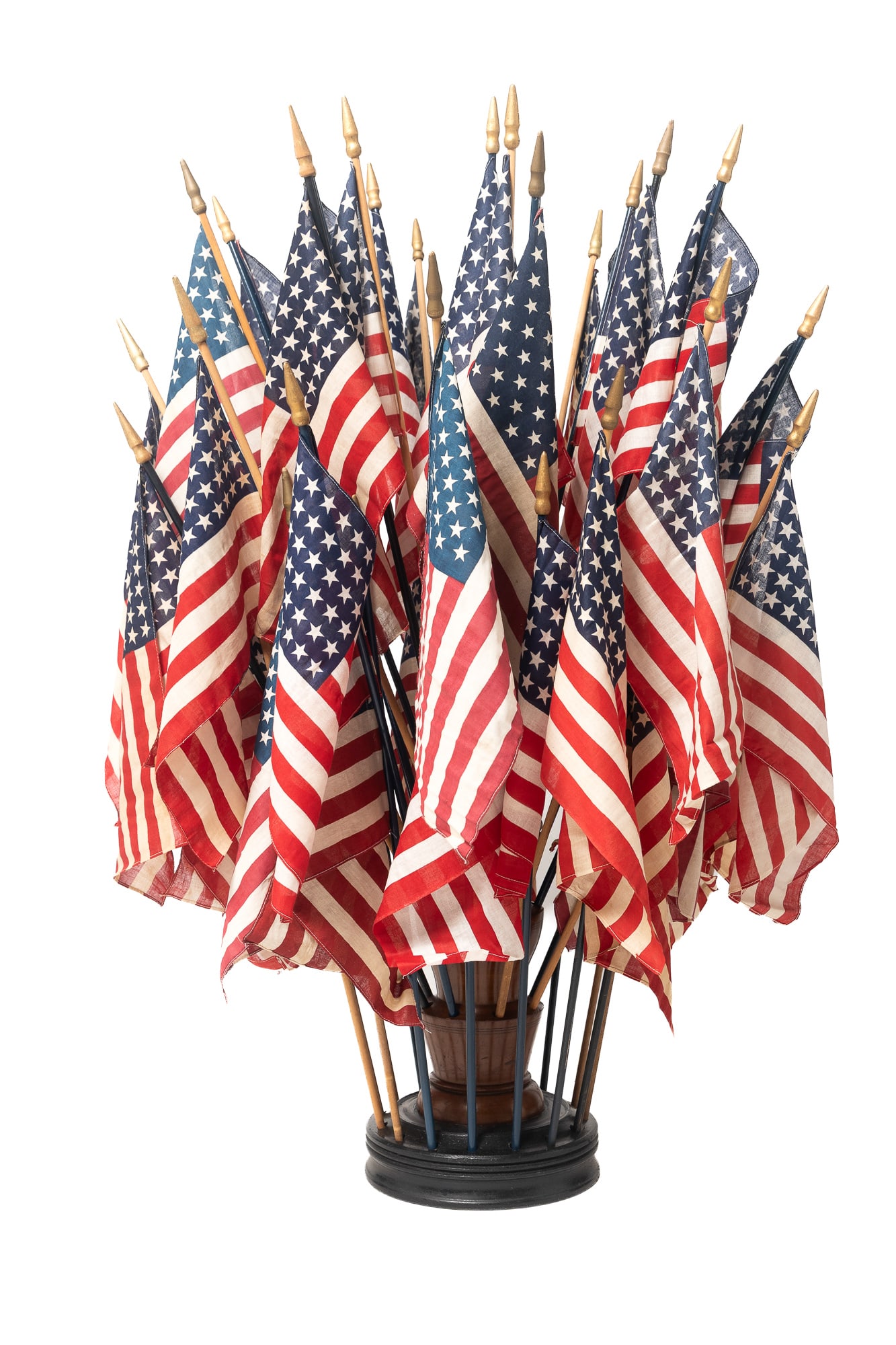 AMERICAN FLAG STORE DISPLAY STAND.: AMERICAN FLAG STORE DISPLAY STAND. American, late 19th Century. Turned cherry pedestal on a round base with black point. Pedestal and base drilled to display. 12"h. 16"w. Flags, 19"h. Pedestal, 49"h.