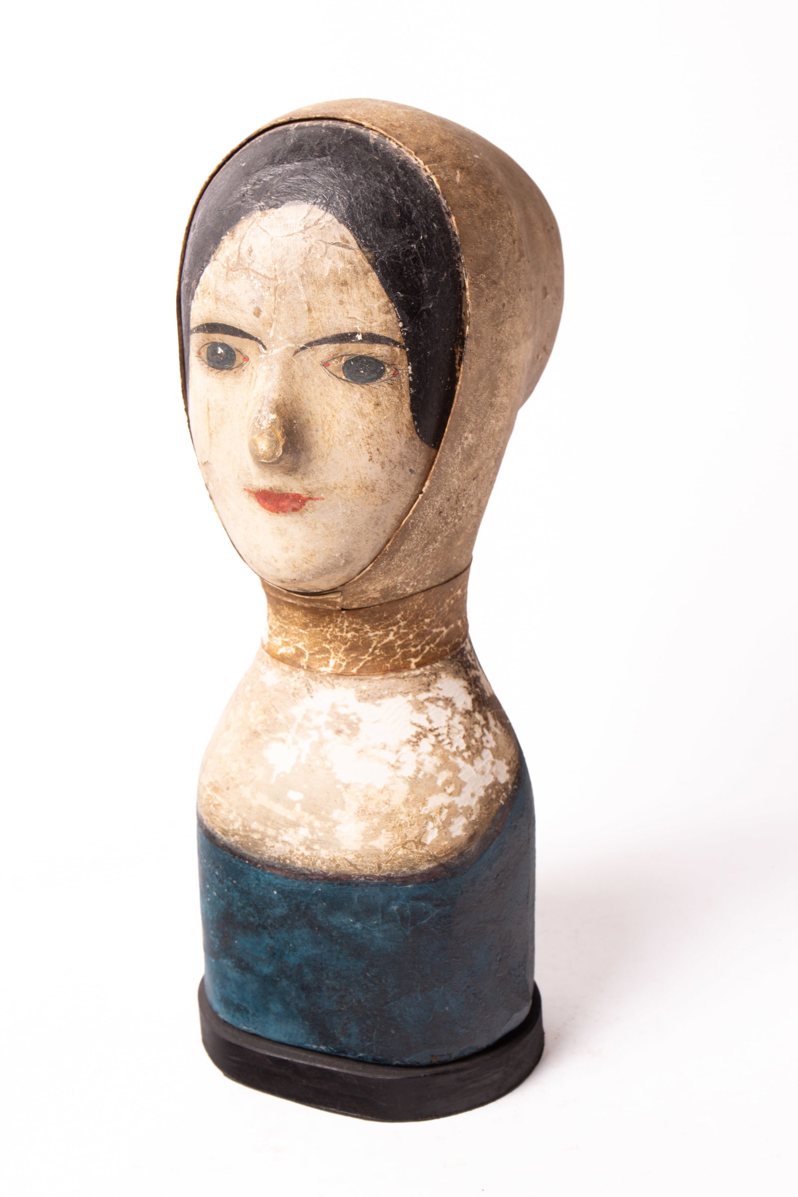 MILLINER'S HEAD WITH LEATHER CAP.: MILLINER'S HEAD WITH LEATHER CAP. French, 19th Century. Papier-mache with painted features including black hair, blue eyes, and red lips; having a leather hat form, strap collar, and on a wood base. 1