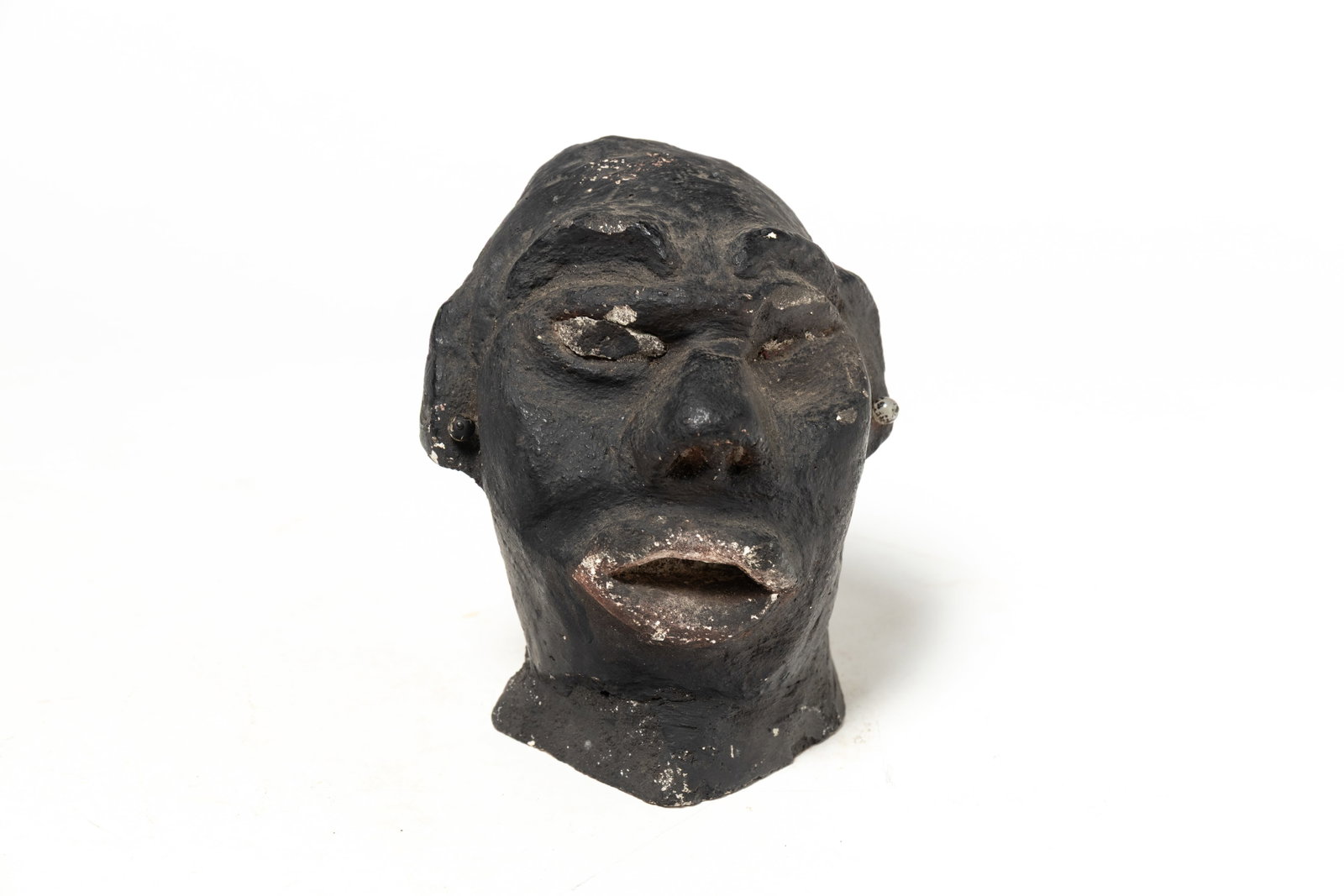FOLKSY PAINTED PLASTER BUST OF A MAN.: FOLKSY PAINTED PLASTER BUST OF A MAN. American, 19th or 20th Century. Folk art rendering of an African American wearing earrings and painted black. 6.75"h. 5.5"w. Provenance: Nancy Goff (Alliance, Ohi