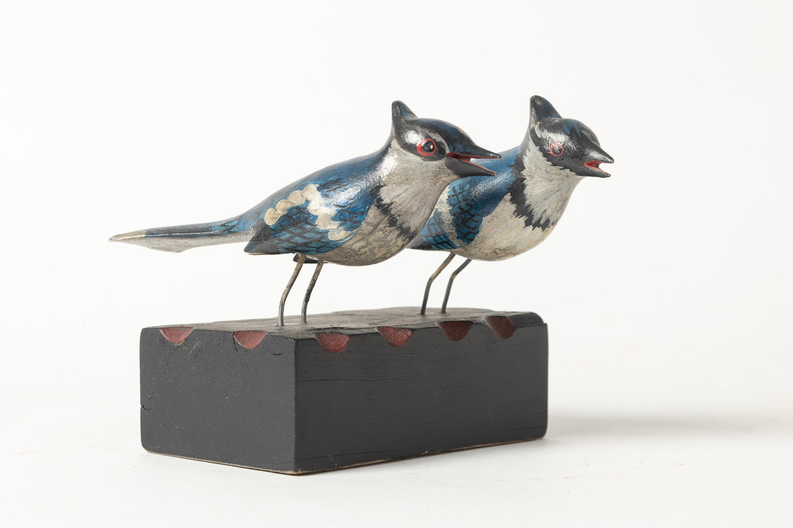 PAIR OF CARVED AND PAINTED BLUE JAYS ON STAND.: PAIR OF CARVED AND PAINTED BLUE JAYS ON STAND. American (likely Pennsylvania), Early 20th Century. A painted rectangular base with clipped edges, with two resting blue jays in good original polychrome
