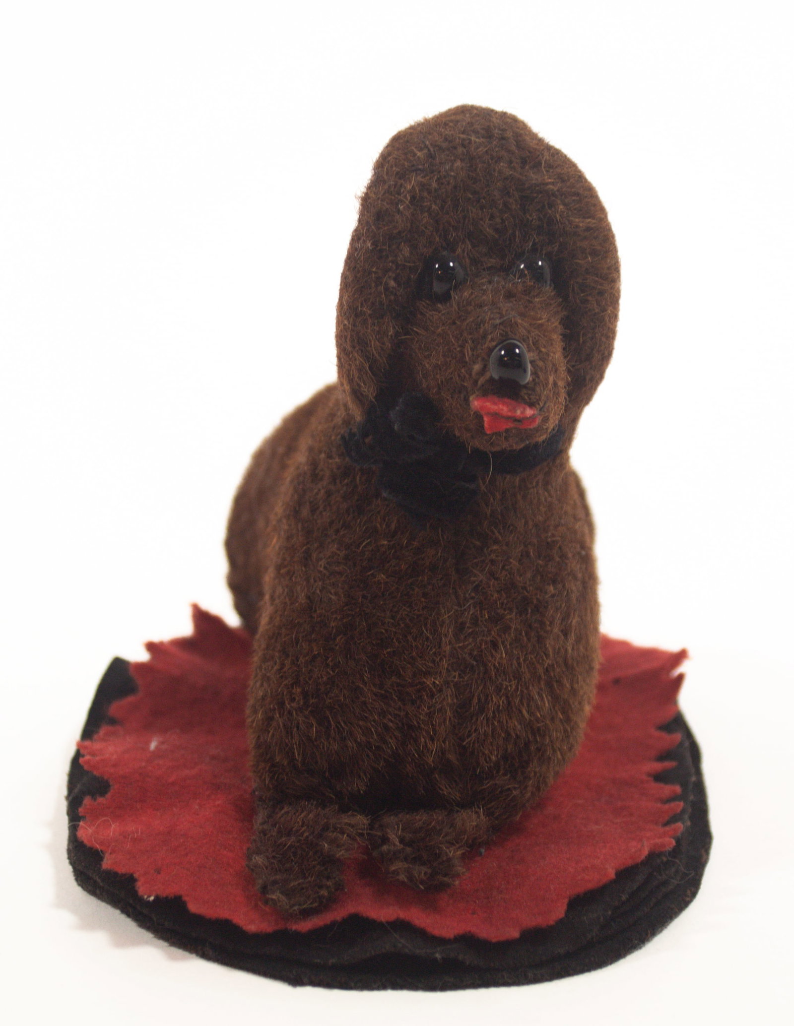 FELT PEN WIPE WITH OVERSIZED DOG.: FELT PEN WIPE WITH OVERSIZED DOG. American, Late 19th or early 20th Century. Black and red layered oval base with pinked edge and a large brown dog with glass eyes sewn to base. 5"h. 6.5"w. Provenance