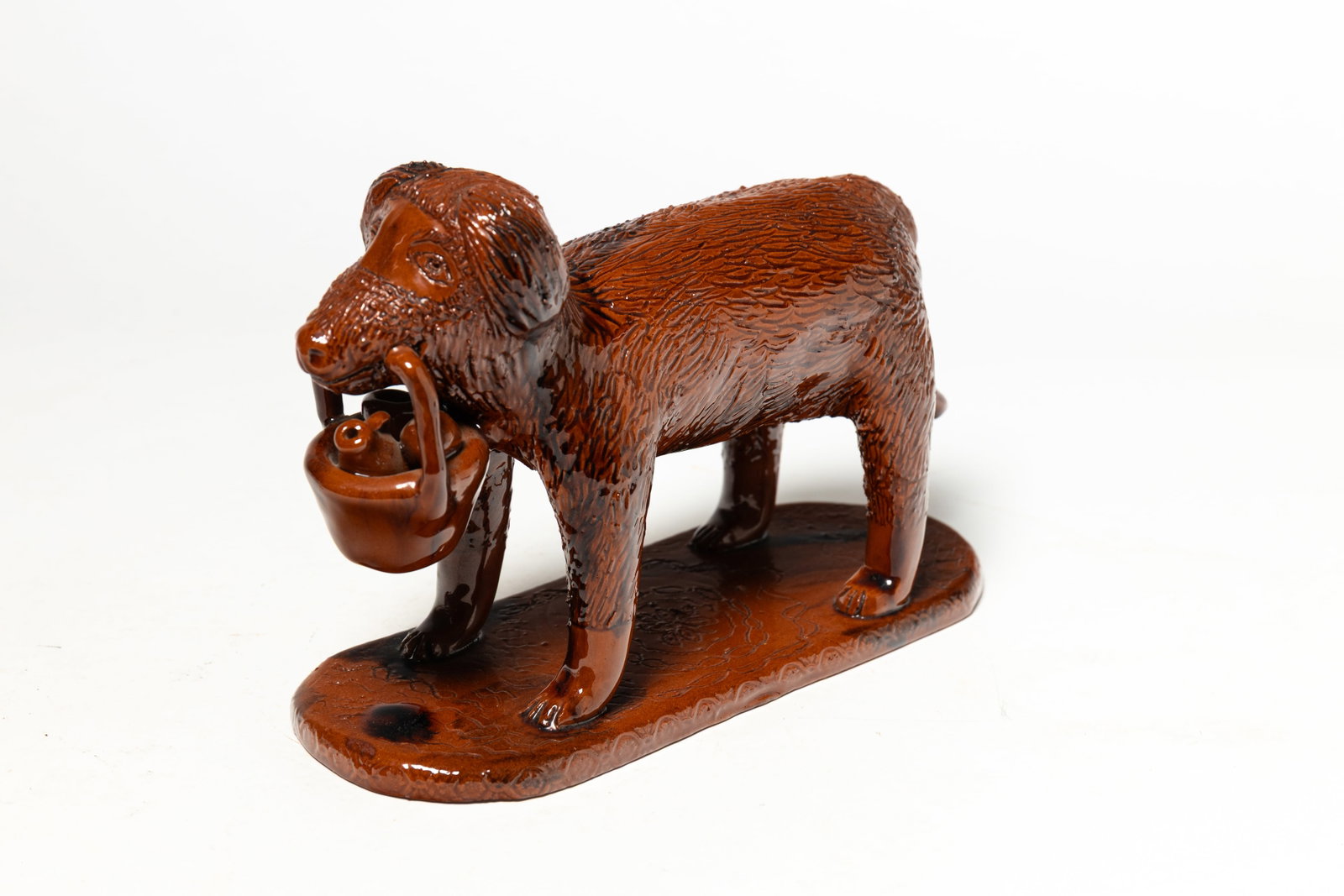 LESTER BREININGER (ROBESONIA, PENNSYLVANIA) GLAZED REDWARE STANDING DOG WITH BASKET OF POTTERY. (1 of 5)