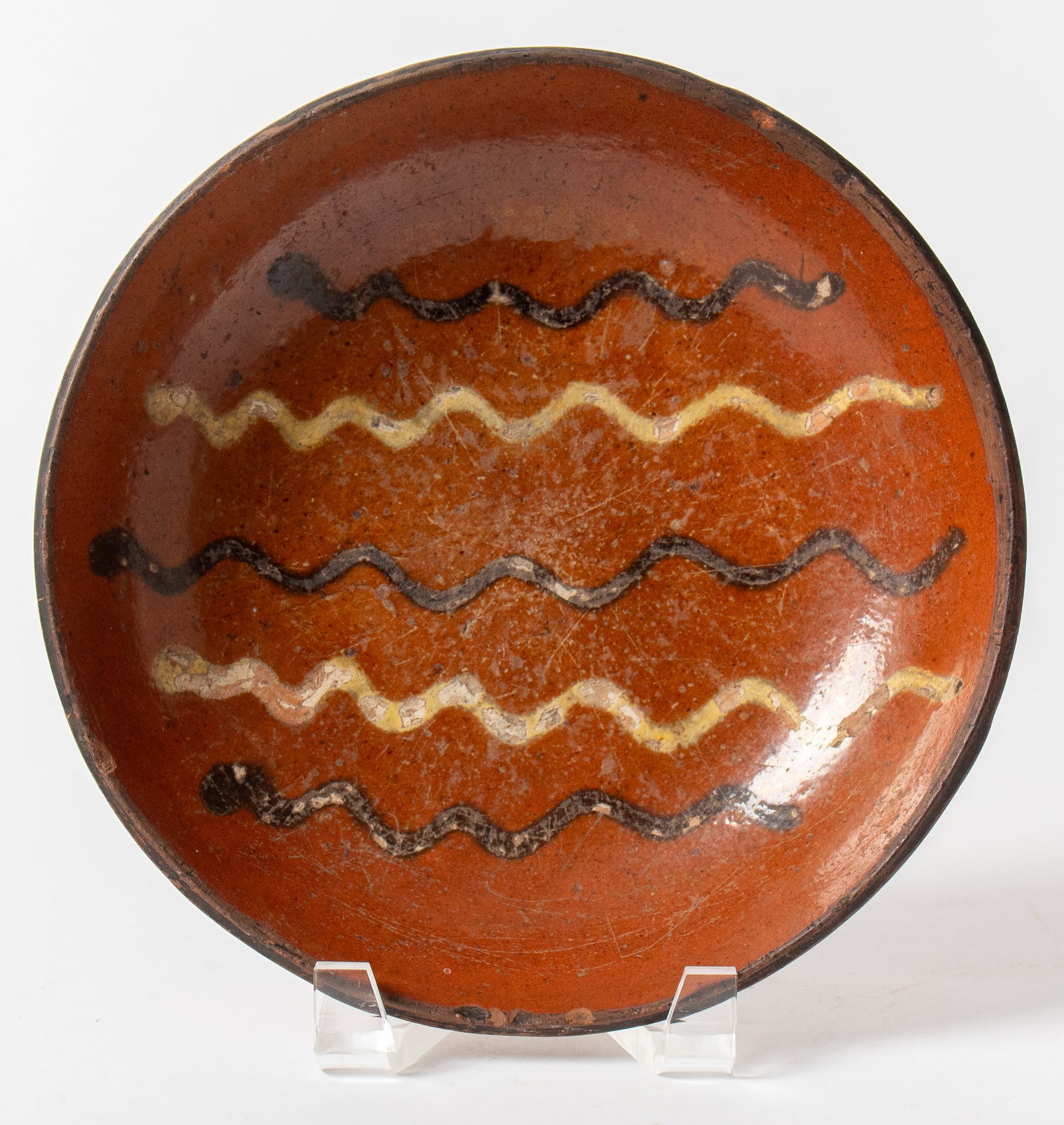 WILLOUGHBY SMITH (WOMELSDORF, PENNSYLVANIA, 1839-1904) SLIP-DECORATED REDWARE SHALLOW BOWL. (1 of 3)
