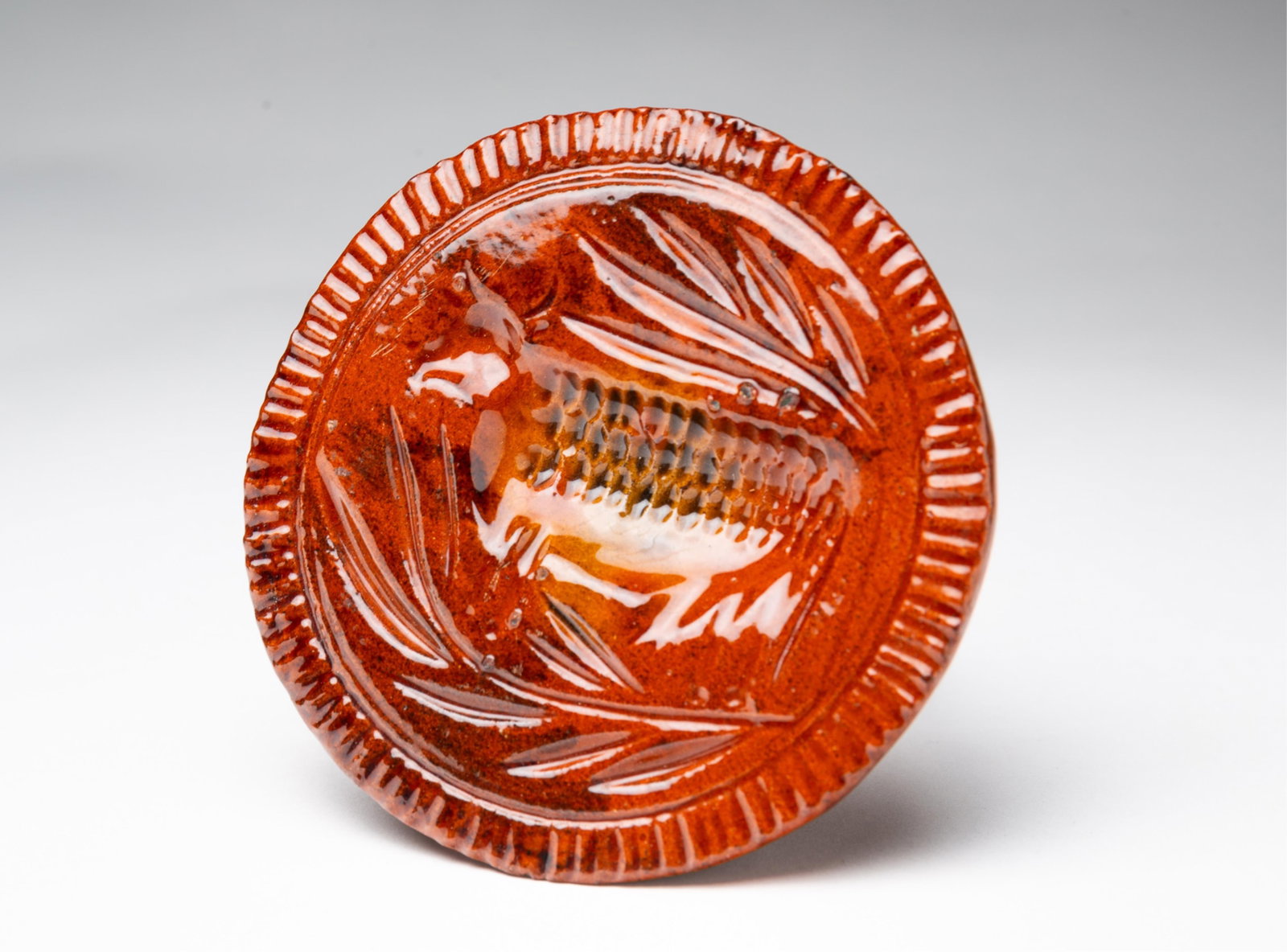 LESTER BREININGER (ROBESONIA, PENNSYLVANIA) GLAZED REDWARE BUTTER PRINT. (1 of 4)