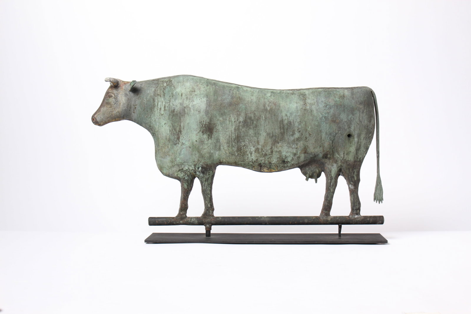 COPPER AND ZINC FULL BODIED COW WEATHERVANE.: COPPER AND ZINC FULL BODIED COW WEATHERVANE. American (possibly L.W. Cushing & Sons), late 19th or early 20th Century. With verdigris and gilt surface; having a hollow, molded copper body with zinc ho